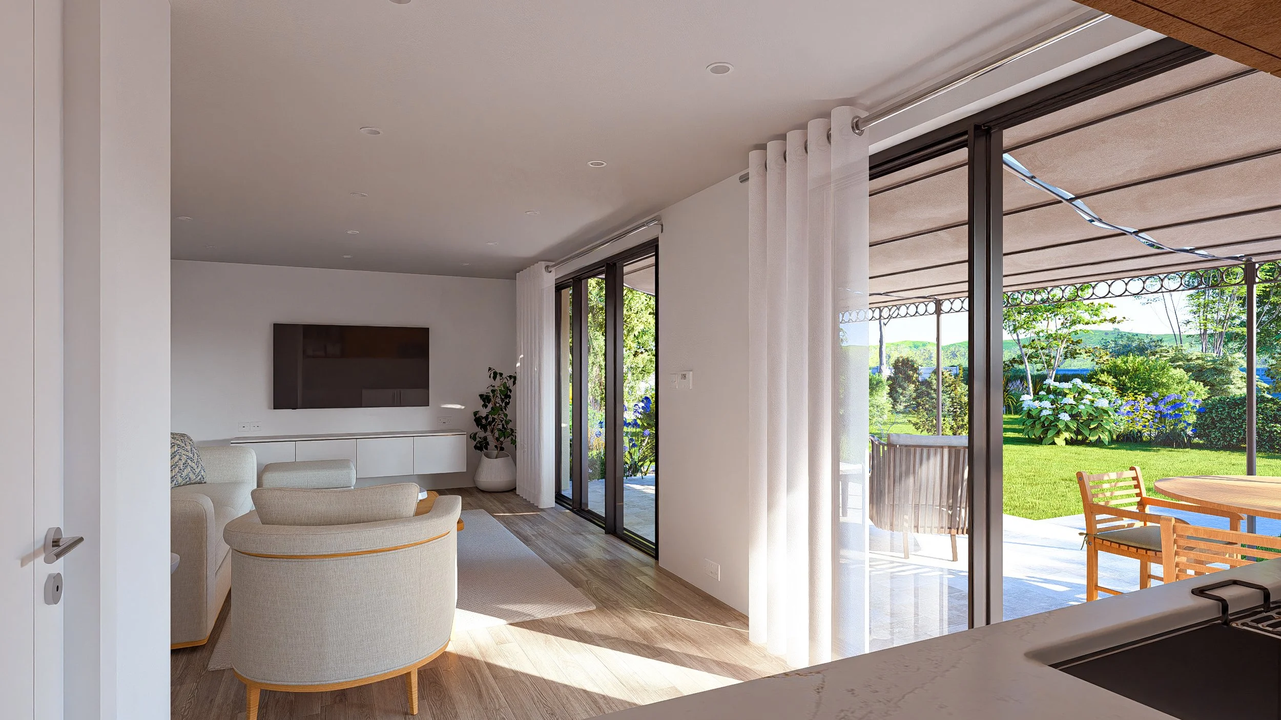 Bauhu hurricane resistant modular home Living room with a large flat-screen TV, white cabinetry, beige furniture, and sliding glass doors leading to a backyard with outdoor table and chairs, green lawn, and trees.