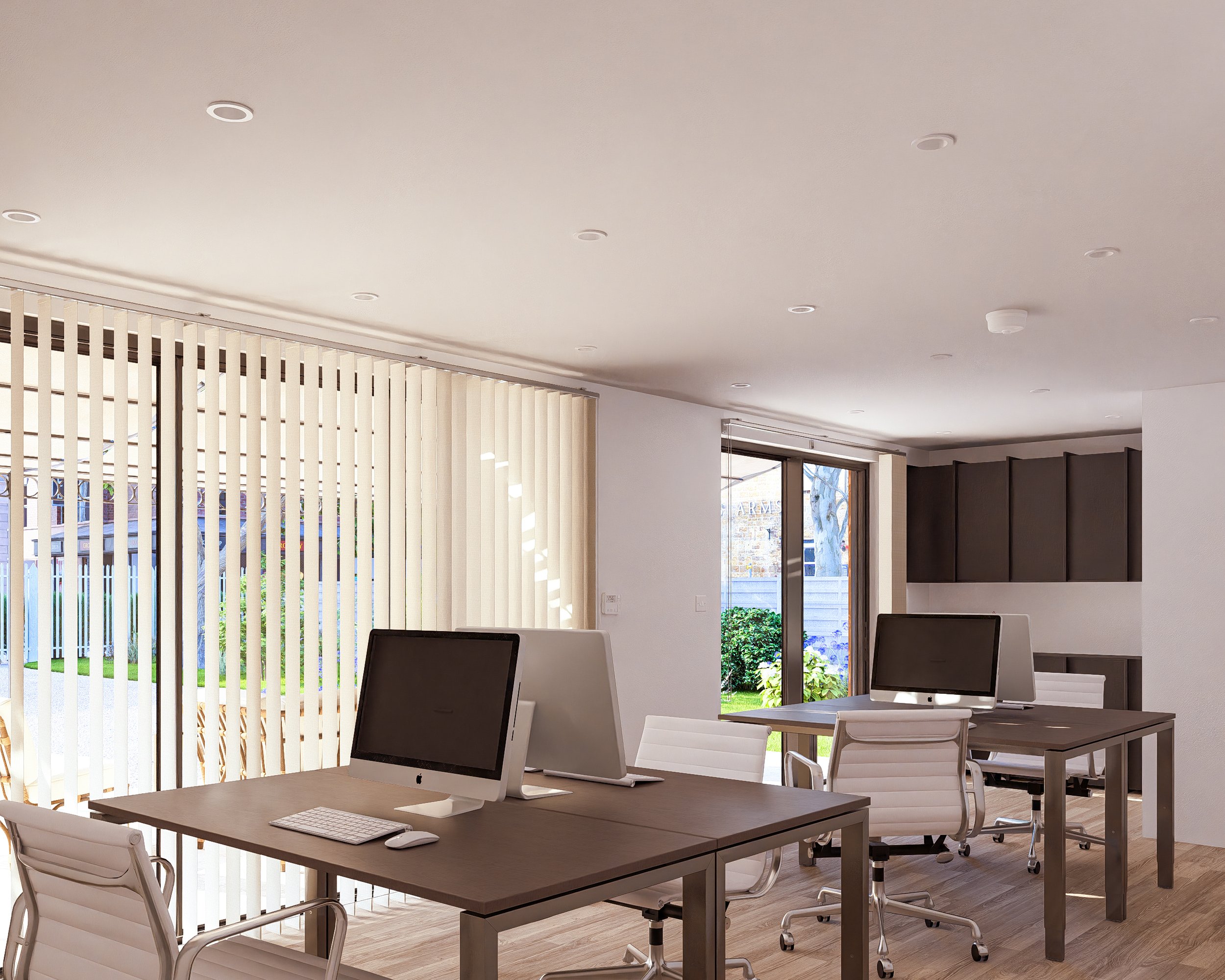 Bauhu hurricane resistant modular hospitality pod Modern office space with white chairs, desks, and Apple computers, large windows with vertical blinds, and a view of a garden outside.