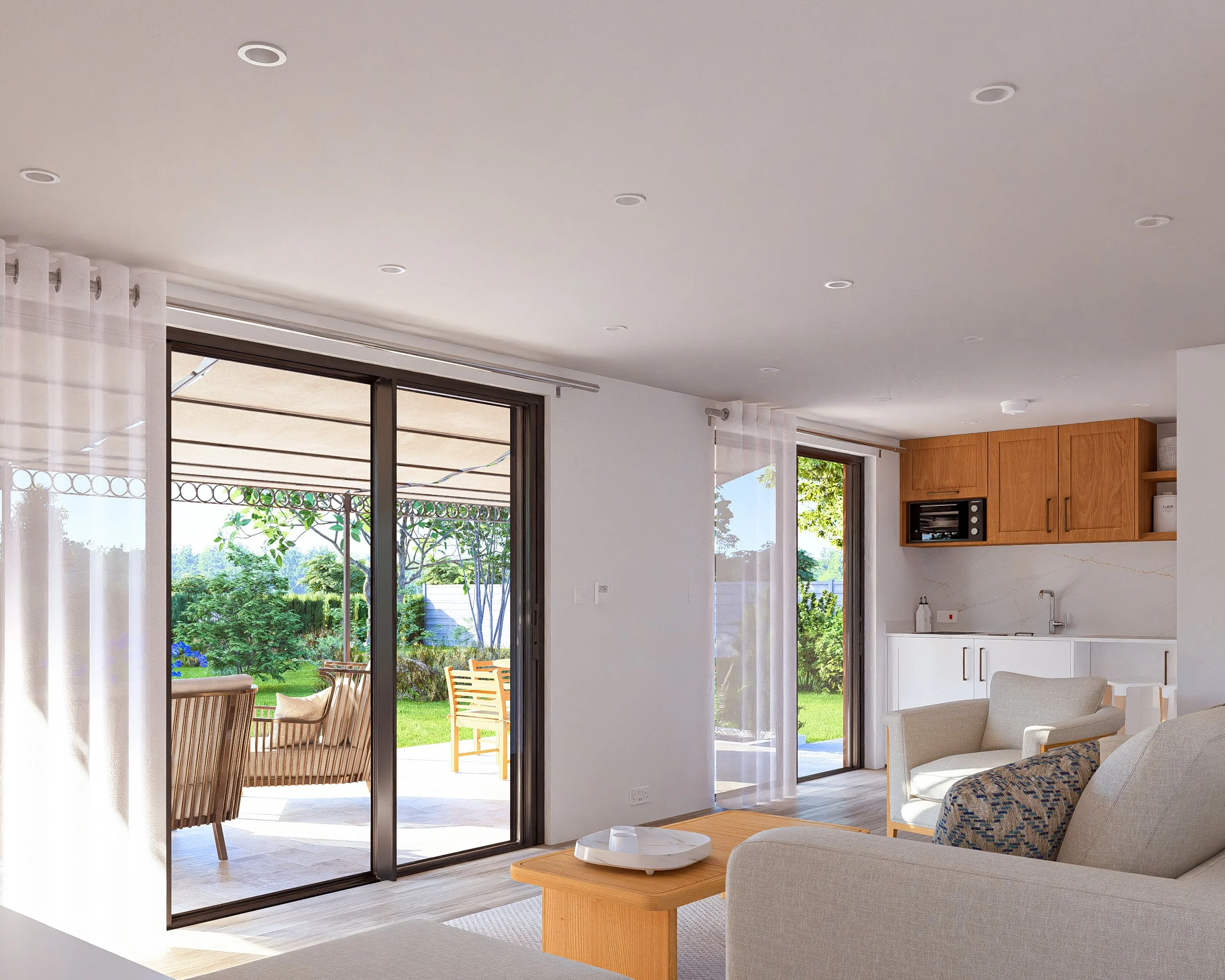 Bauhu hurricane resistant modular hospitality pod Living room with sliding glass doors leading to a patio and garden, featuring outdoor seating, next to a kitchen area with wooden cabinets, white countertops, and a small oven.