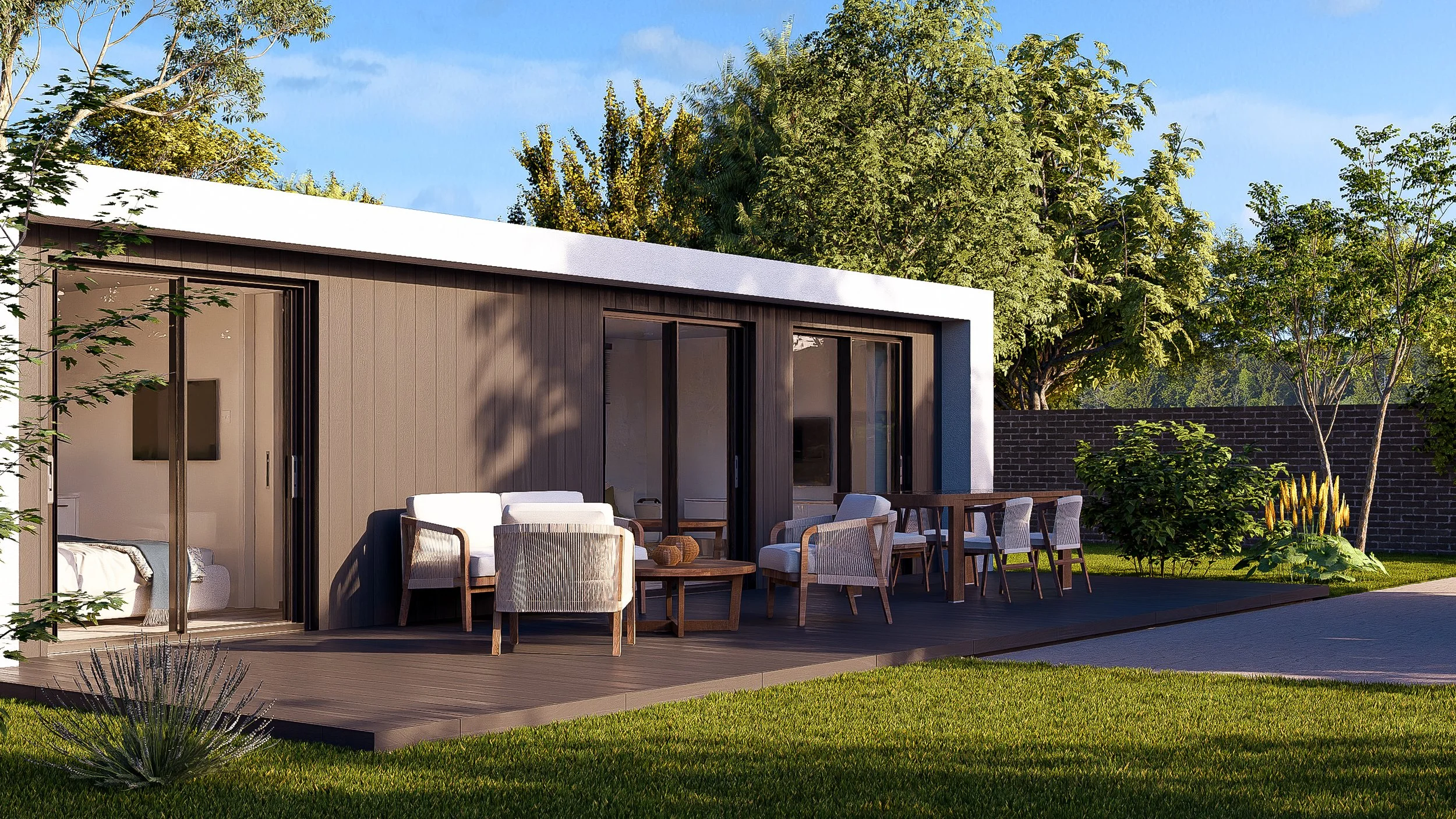 Bauhu hurricane resistant modular hospitality pod  patio with outdoor seating and dining area, surrounded by green grass, trees, and a brick wall in the background.