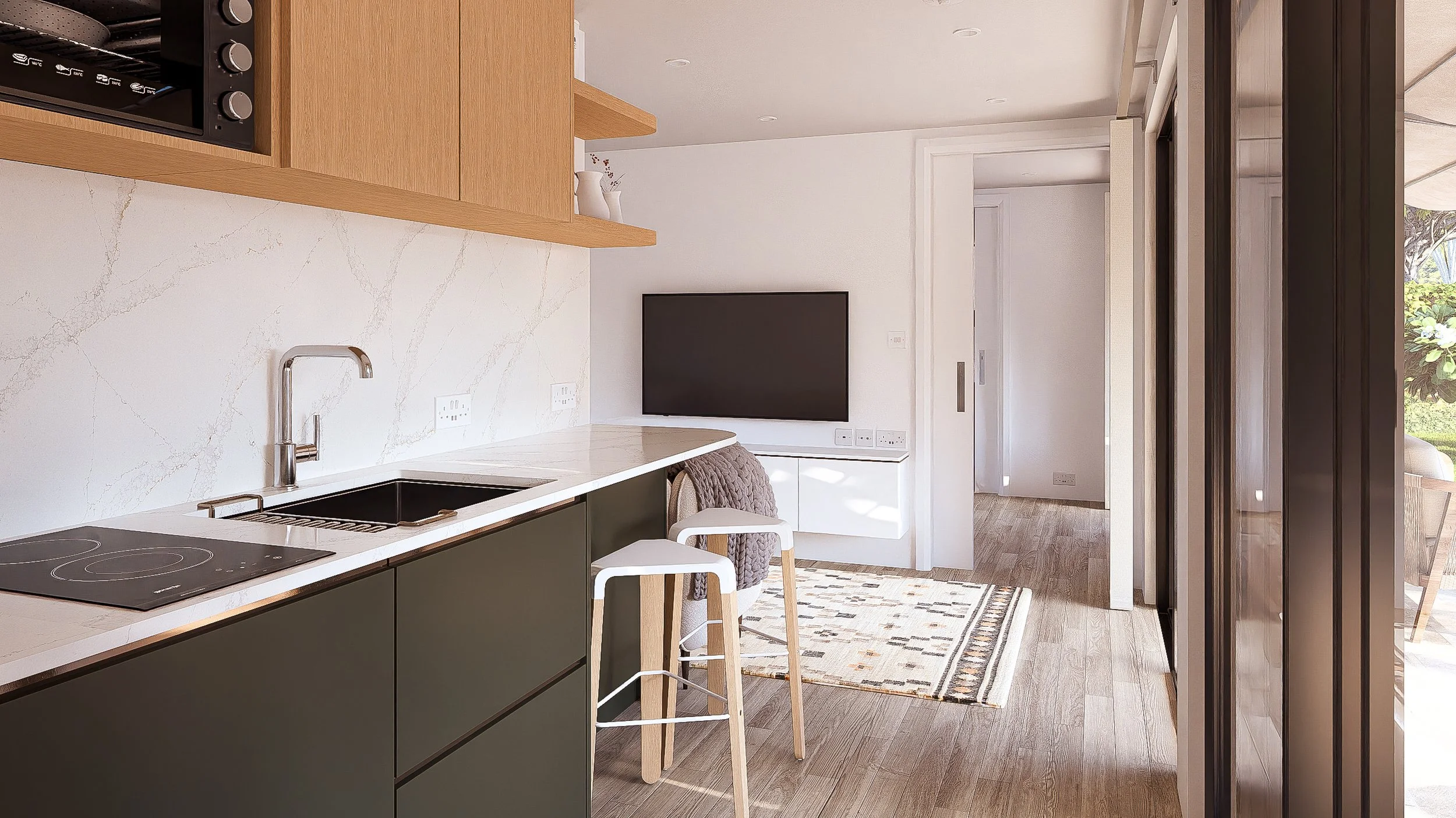 Modern kitchen with wood and black cabinetry, white countertop, and an induction cooktop. A sink with a chrome faucet. Two white bar stools with light wood legs, one draped with a gray throw. A TV on a white cabinet, a patterned rug, and a sliding gl