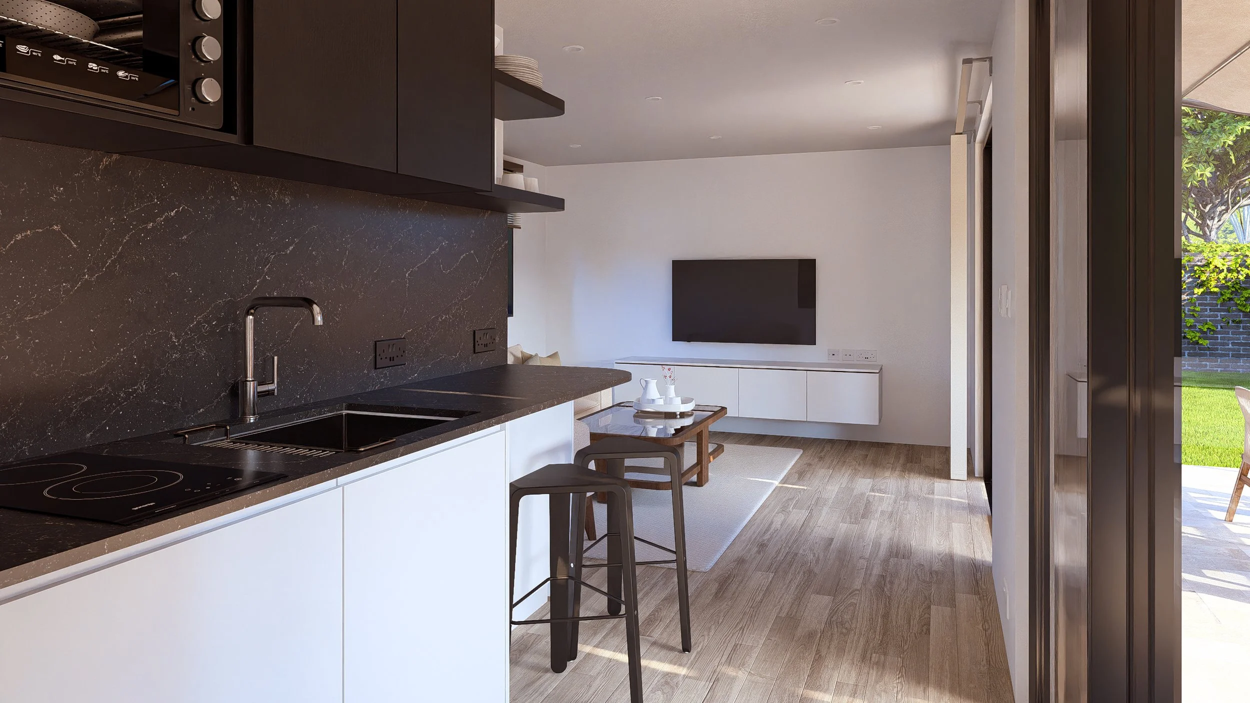 Modern Bauhu hurricane resistant modular hospitality pod kitchen with black countertops, a sink, and black upper cabinets. Open living area with a wall-mounted TV and a view of the outside patio and green yard.