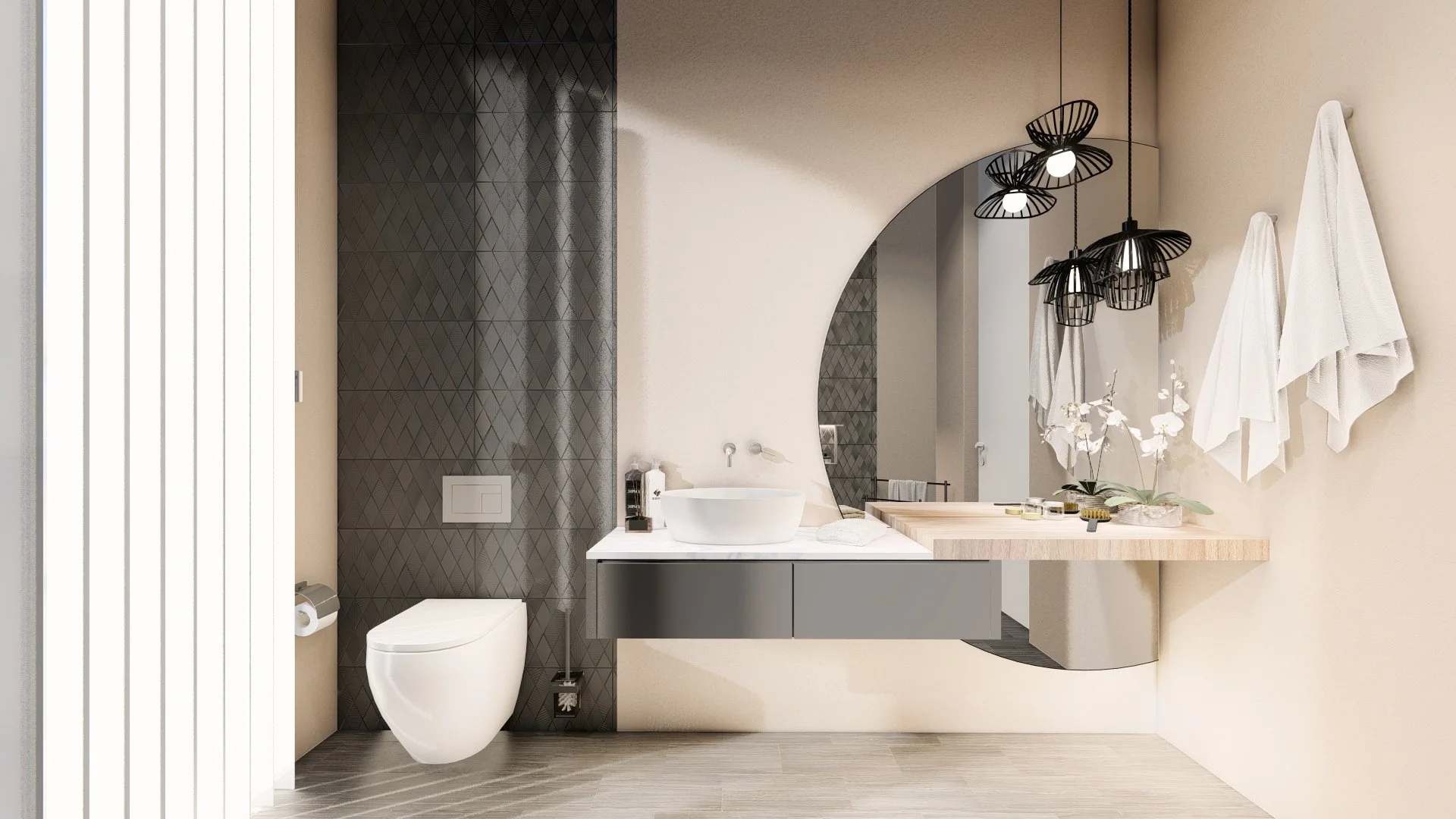 Modern bathroom with beige walls, black patterned shower wall, white toilet, floating vanity with white vessel sink, round mirror, wall-mounted faucet, and hanging black geometric pendant lights. Towels hang on hooks, and decorative plants and toiletries are arranged on the counter.