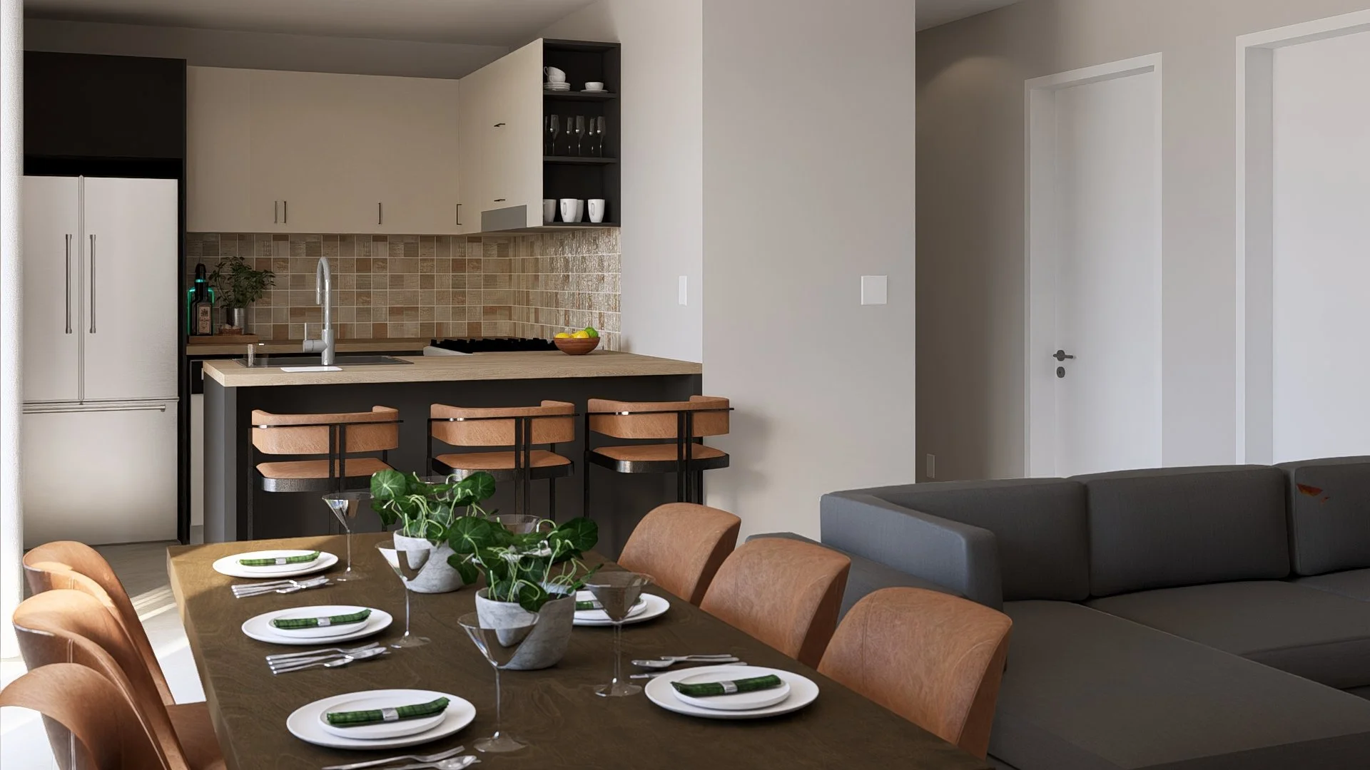 Open-concept modular, hurricane resistant stliving and kitchen area with a dining table set for six, a gray sectional sofa, and a modern kitchen with a beige tile backsplash, lower dark cabinets, light upper cabinets, barstools, and a bowl of lemons.