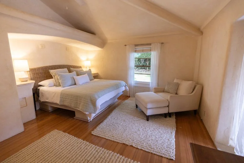 Lino Place, Pukalani: bedroom with wood floors and a sloped ceiling