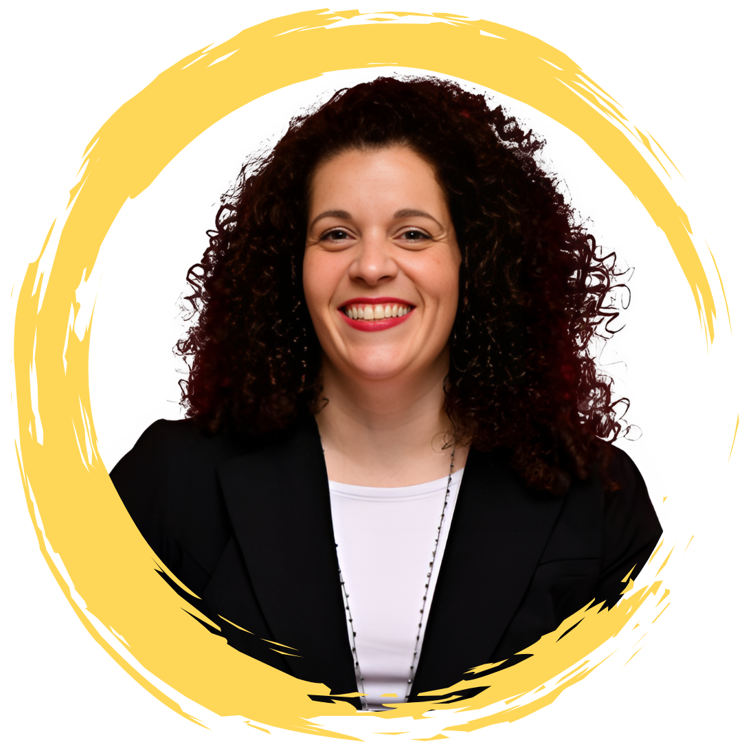 A woman with curly dark hair smiling, wearing a black blazer and white top, framed by a yellow brushstroke circle.