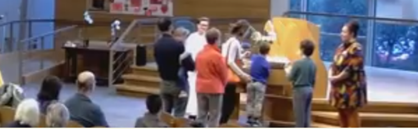 Natasha participating in candle lighting with  congregants