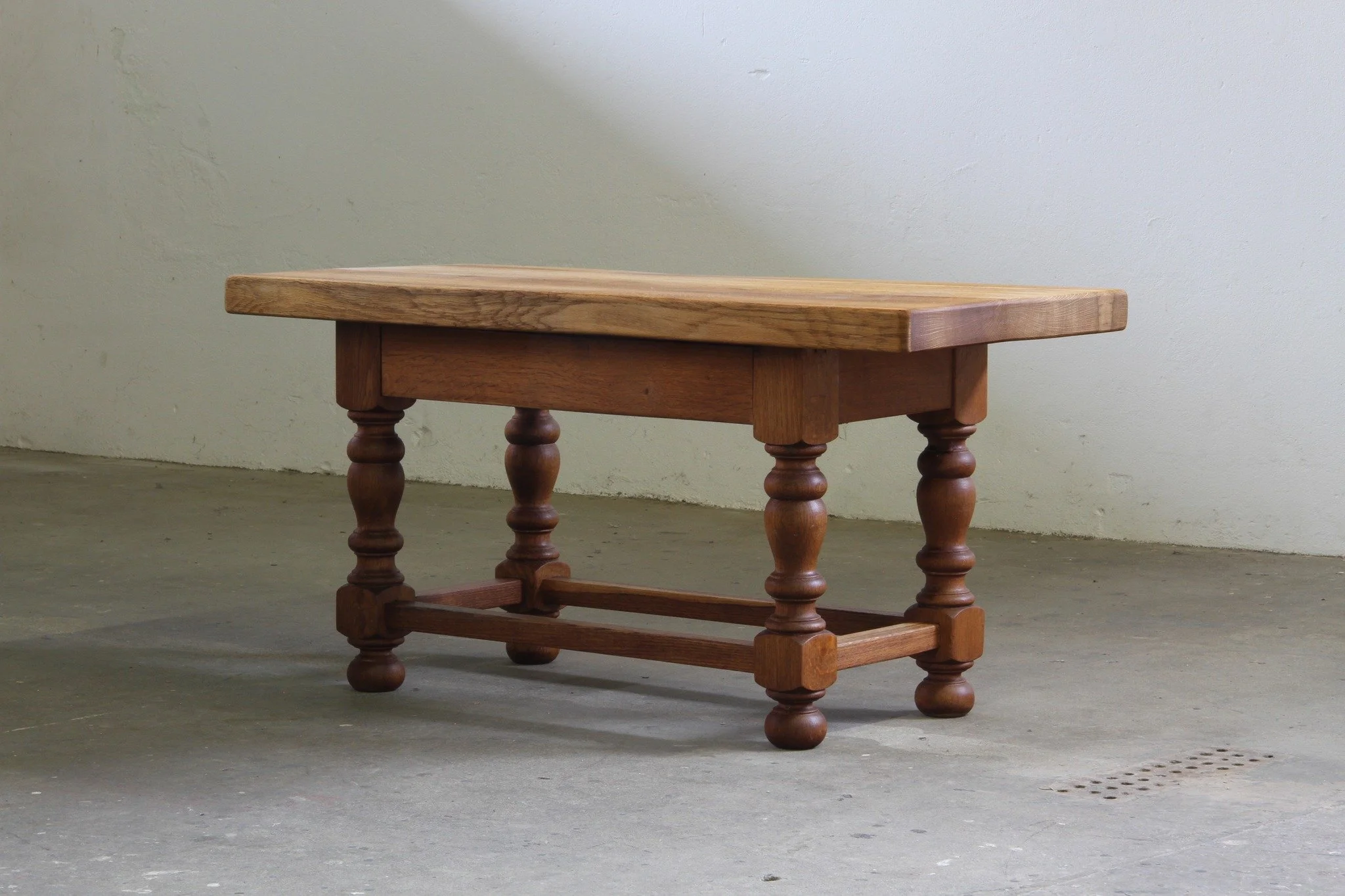 Early 20th Century Danish Baroque Coffee Table, Solid Oak 

SKU: mb00040

Over a century old &mdash; and built to last another. This Jacobean-style Danish farmhouse coffee table features a thick solid oak plank top and bold baluster-turned legs that 