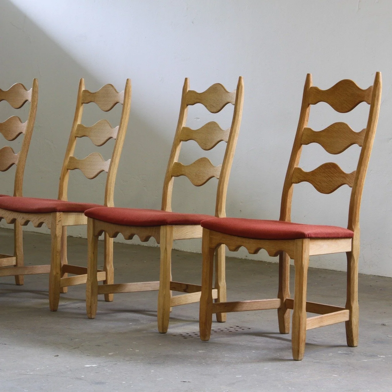 Vintage 1960s Danish Brutalist Ladderback Light Oak Chairs, style of Kj&aelig;rnulf 
SKU: mb00043

Tall, bold, and unmistakably Danish. This set of 4 carved light oak ladderback chairs &mdash; inspired by Kj&aelig;rnulf's iconic "Razorblade&quot