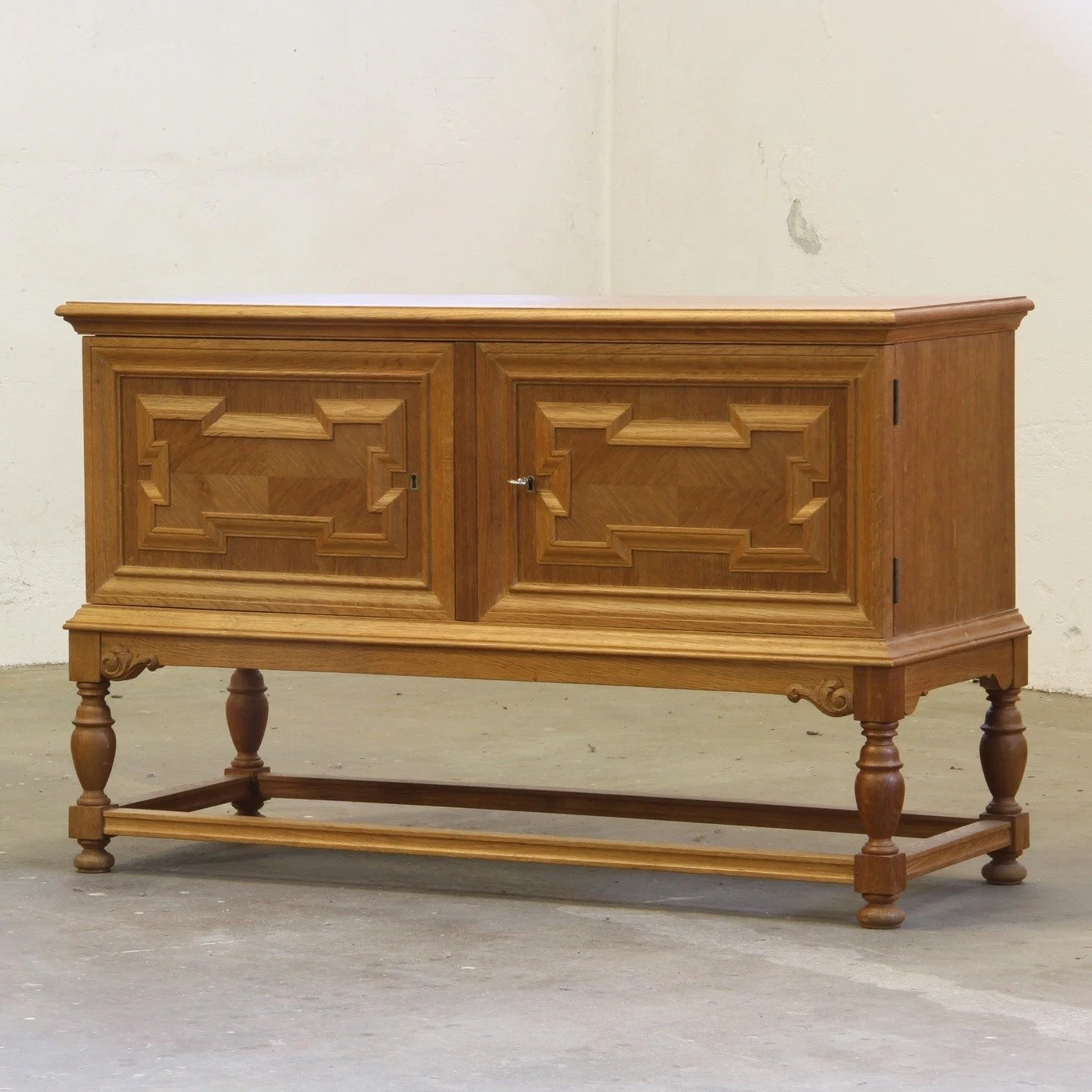 1960s Vintage Low Sideboard / Credenza Cabinet in Oak, Danish Baroque Style 

SKU: mb00049

Big storage, slim presence. This rare solid oak Danish credenza from the 1960s is full of contradictions &mdash; heavy yet elegant, bold Brutalist legs yet al