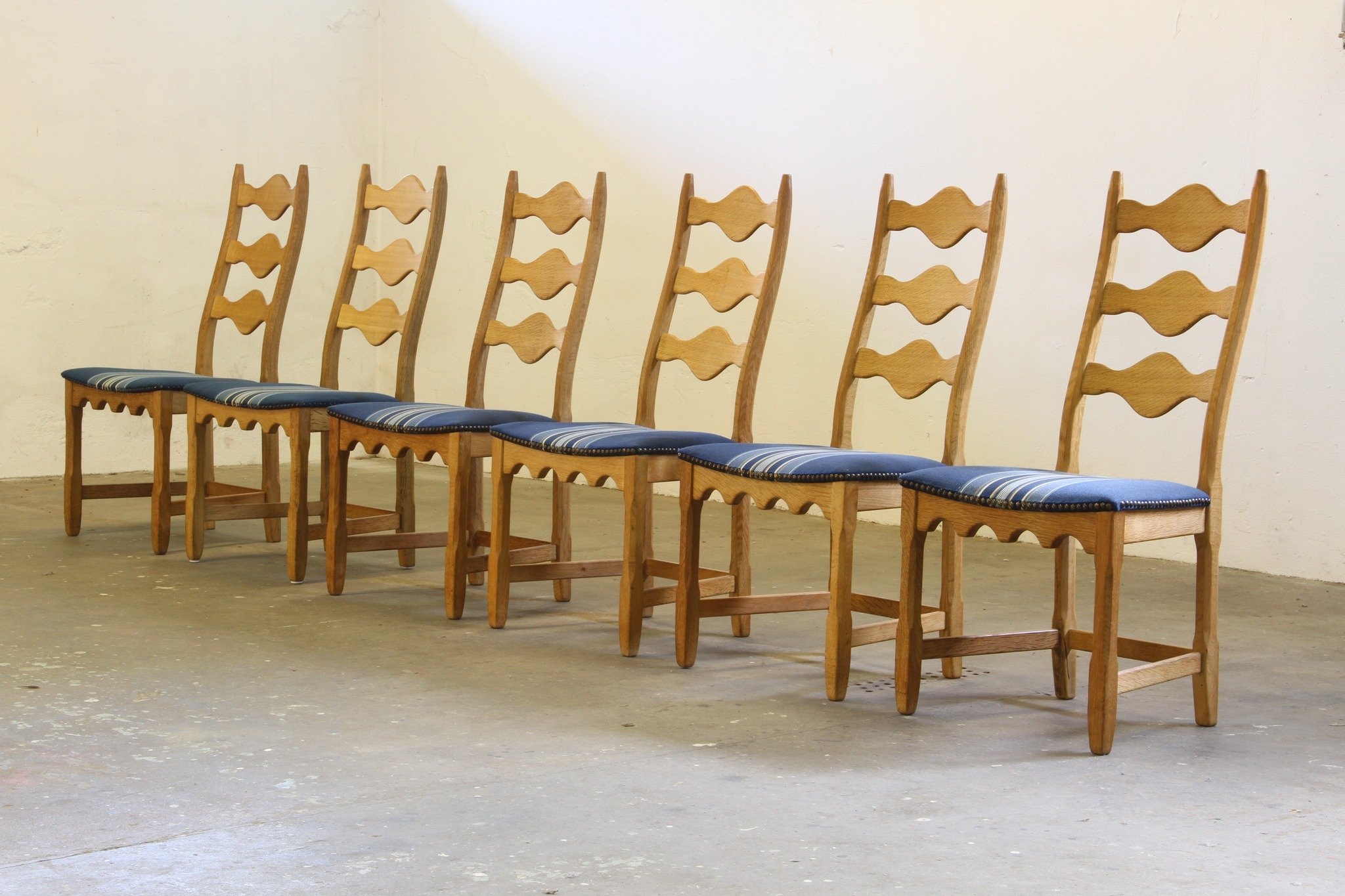 Vintage 1960s Danish Brutalist Oak Ladder Dining Chairs, style of Kj&aelig;rnulf 

SKU: mb00051

The iconic Razorblade silhouette &mdash; instantly recognizable, endlessly elegant. This set of 6 carved light oak ladderback chairs by Nyrup M&oslash;be