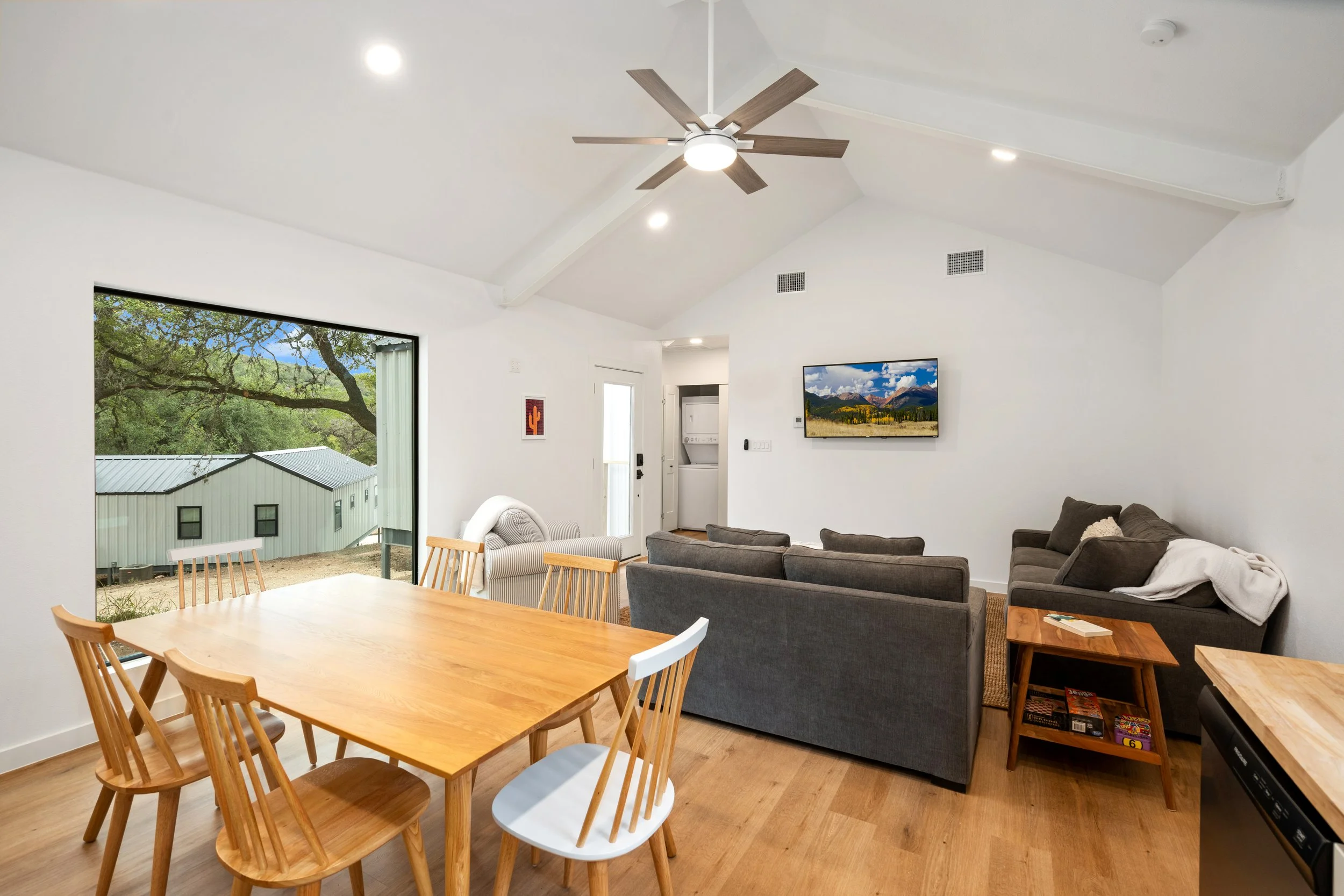 Luxurious Living room with dining table, couch, and tv.
