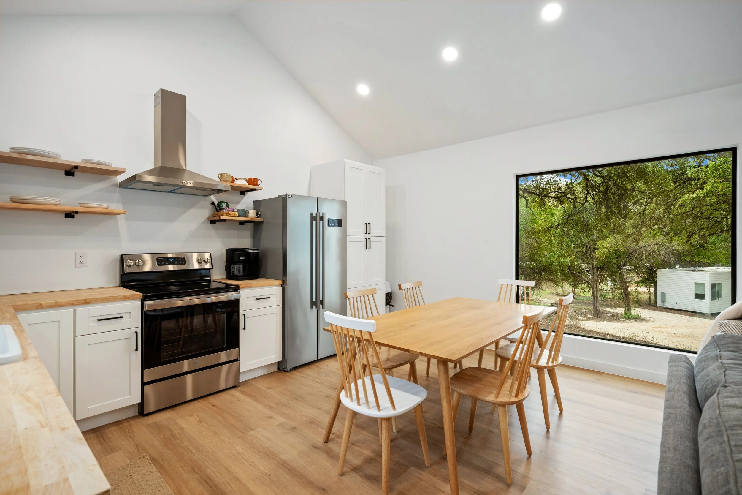 Modern kitchen with high quality appliances  and beautiful wooded view.