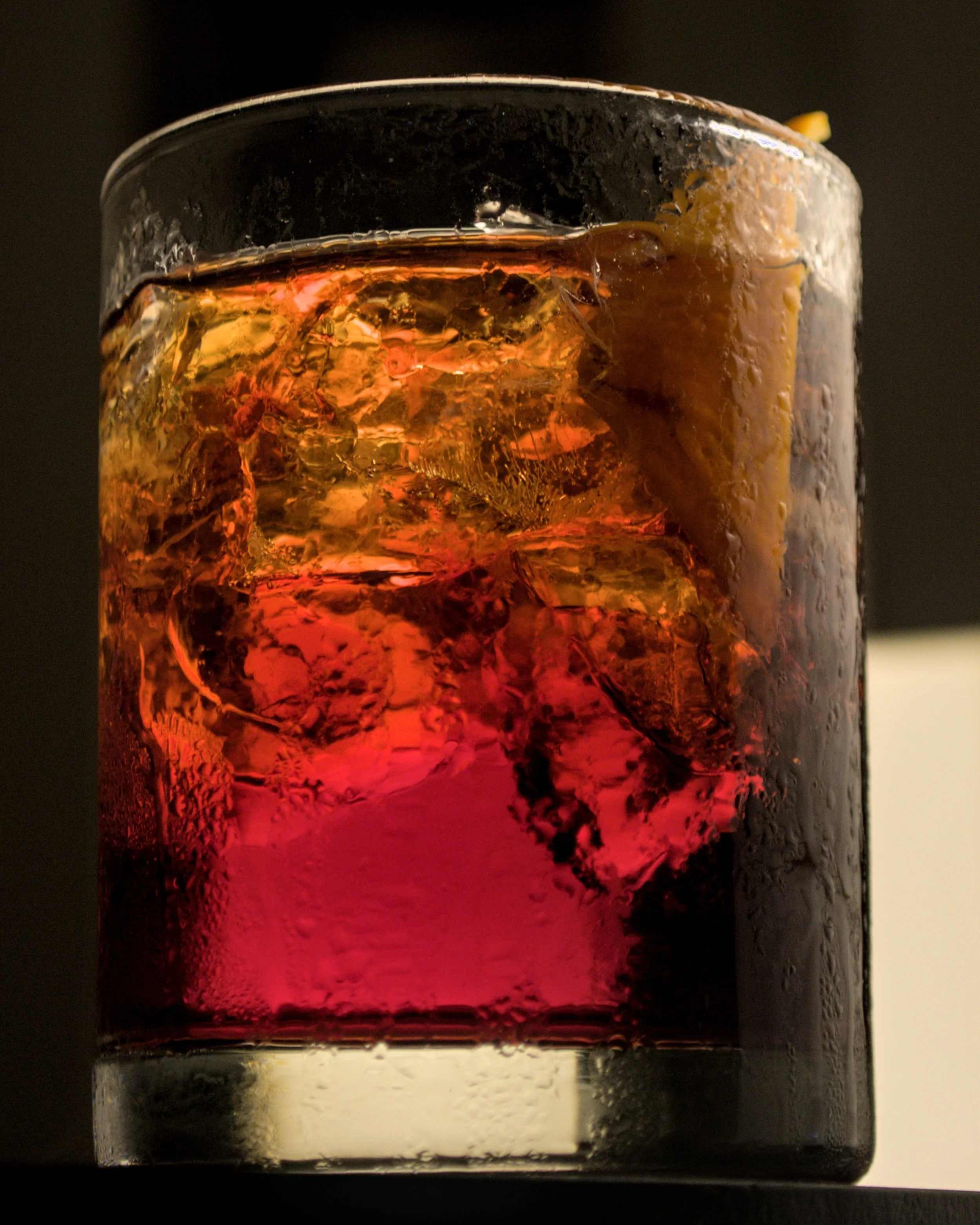This Is an Image of the cocktail Americano, it is red and yellow tone the further up you go.