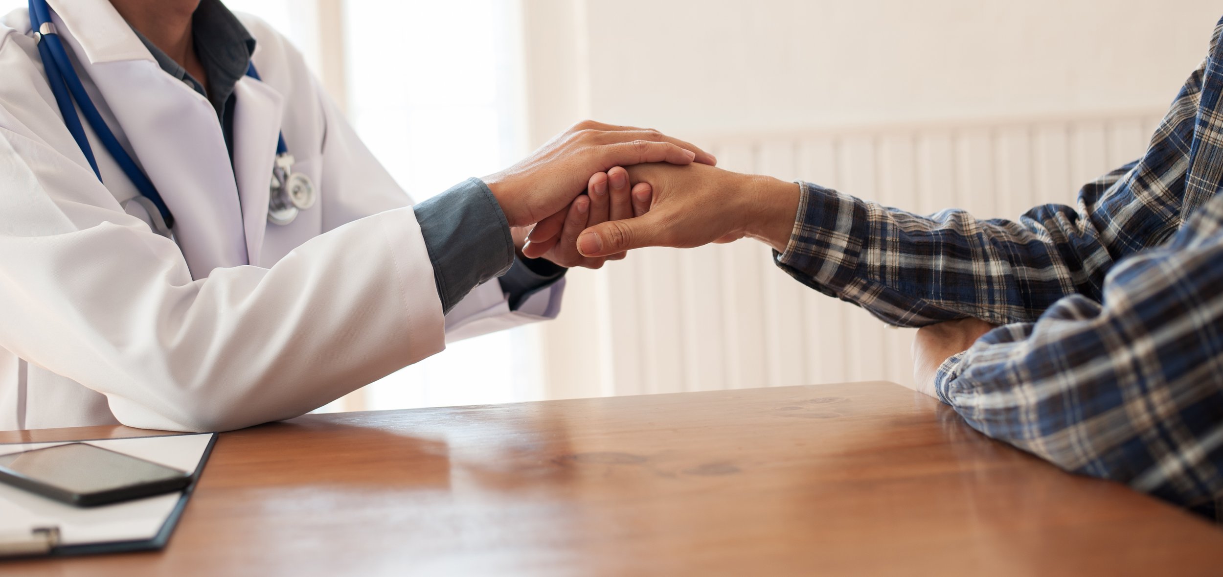 A medical professional comforts a patient