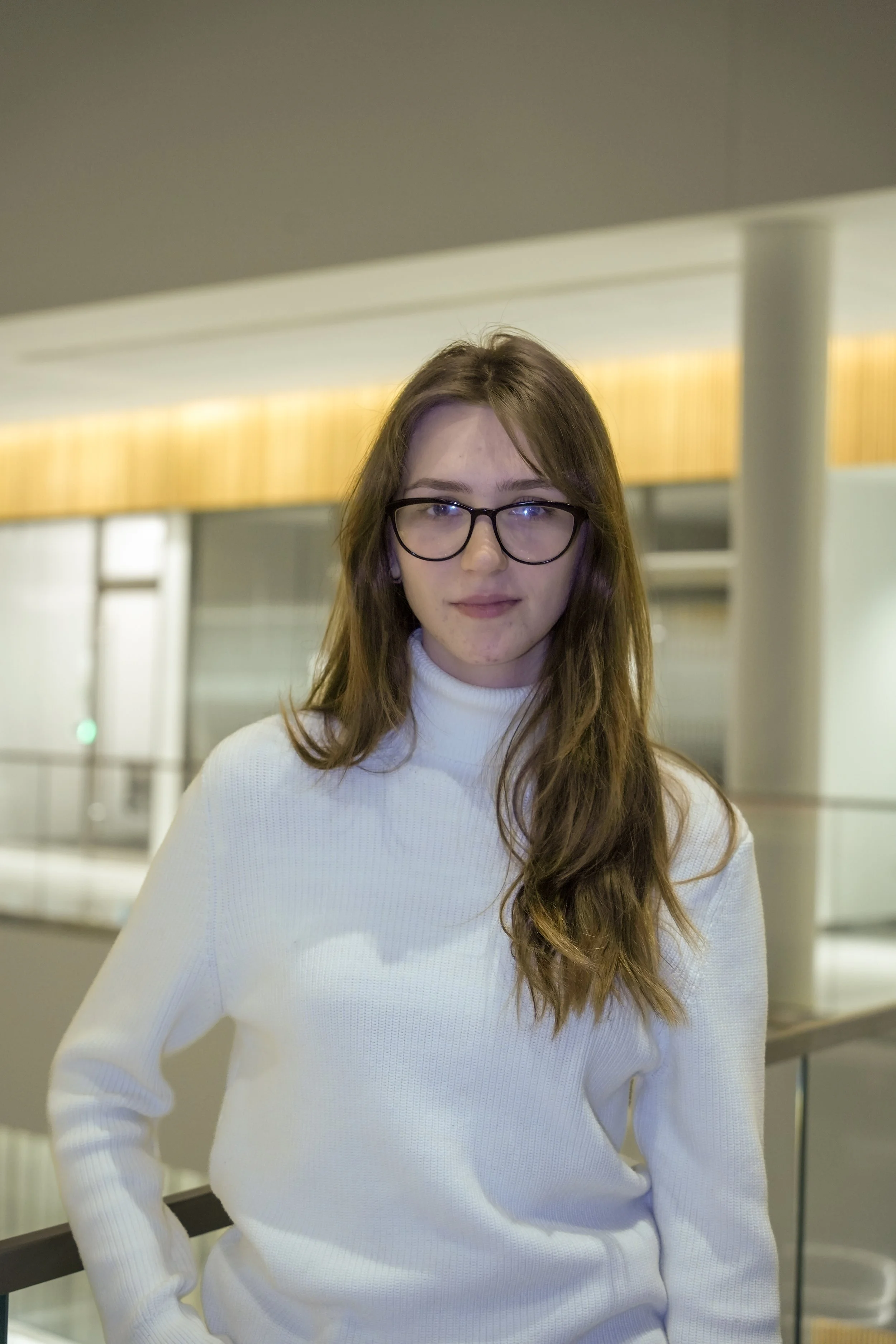 Michigan State University Spartan helmet logo with MSUMA text, in front of a modern building with glass windows and trees.
