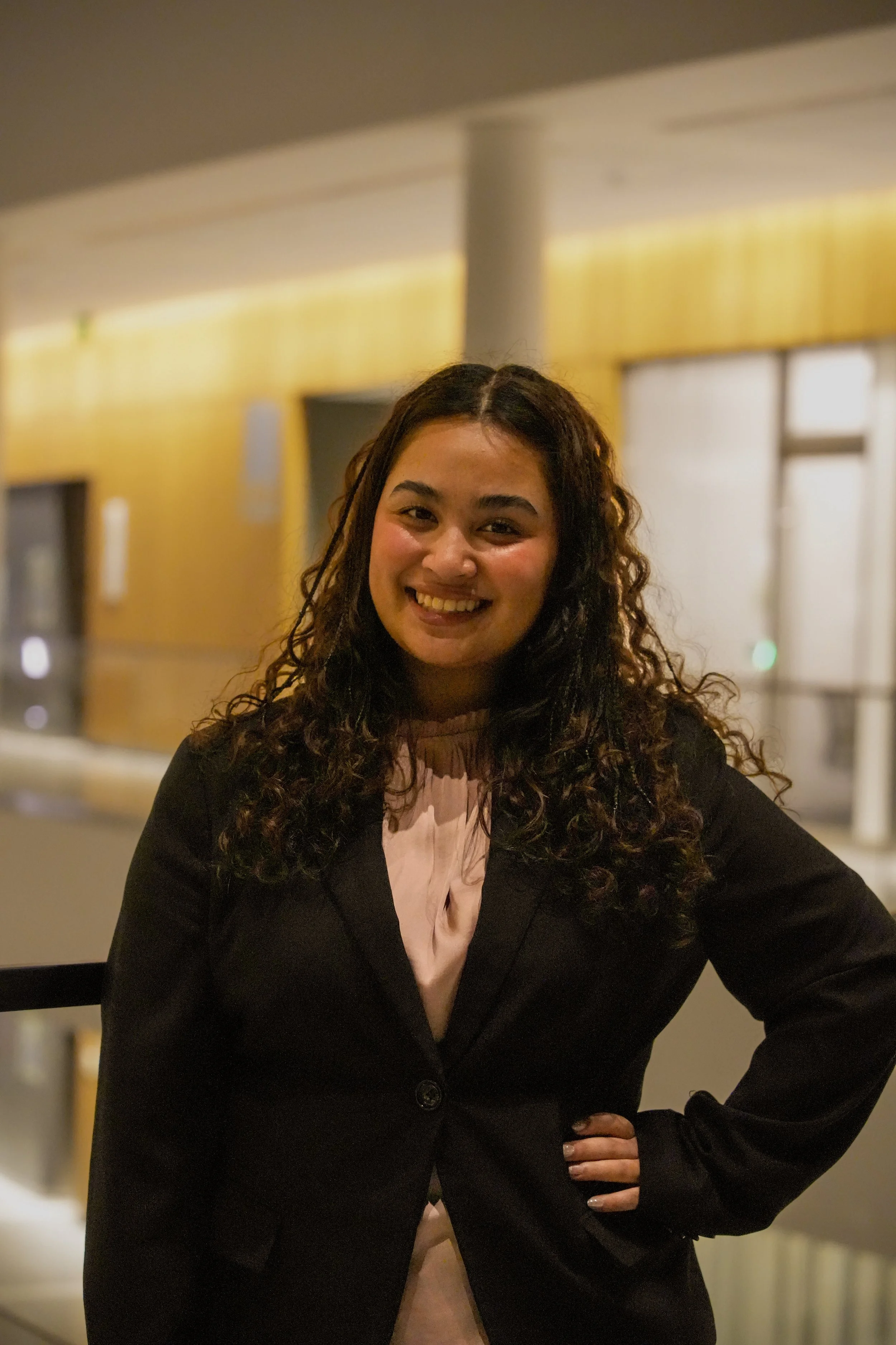 Michigan State University Spartan helmet logo with MSUMA text, in front of a modern building with glass windows and trees.