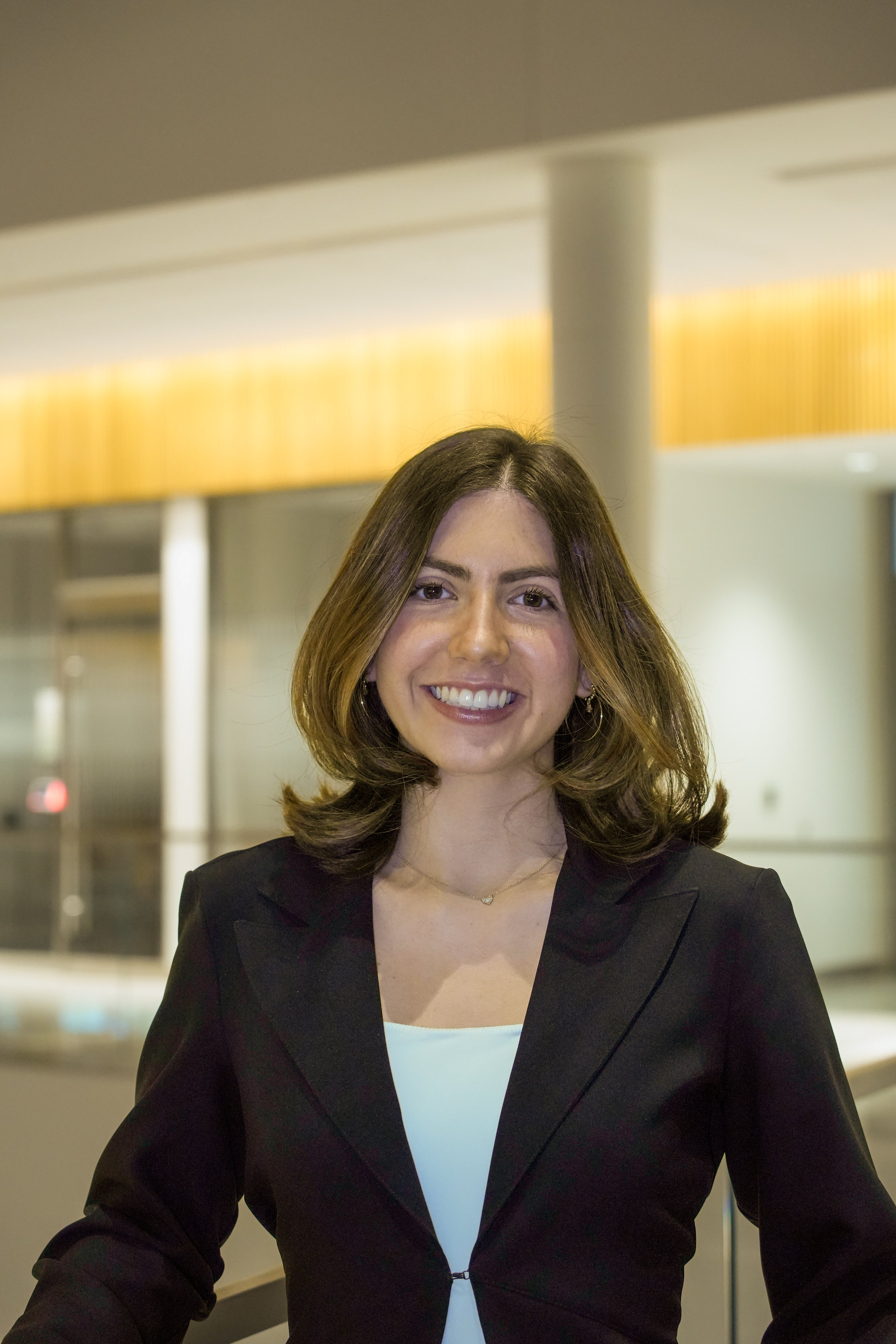 Michigan State University Spartan helmet logo with MSUMA text, in front of a modern building with glass windows and trees.
