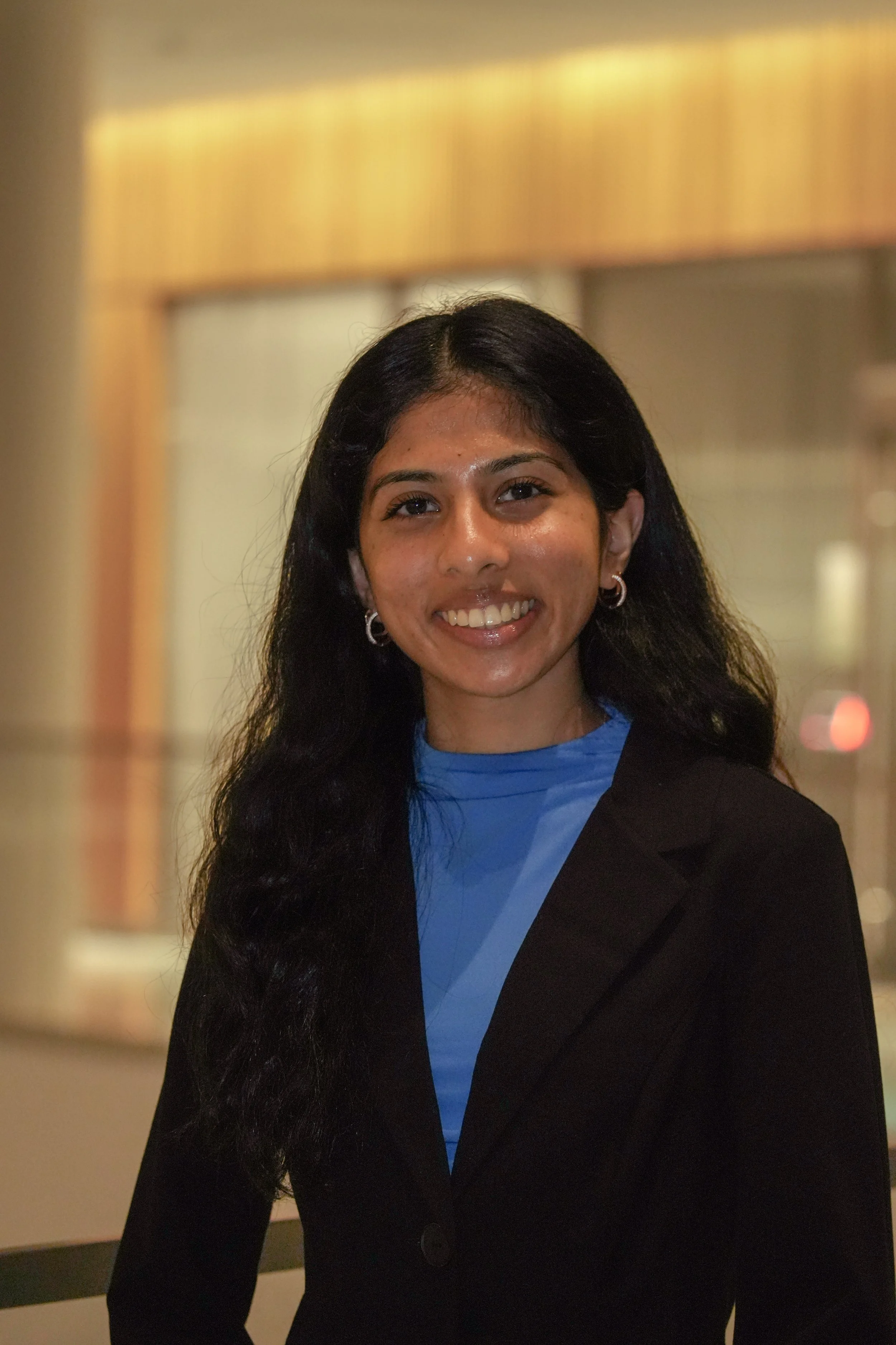 Michigan State University Spartan helmet logo with MSUMA text, in front of a modern building with glass windows and trees.