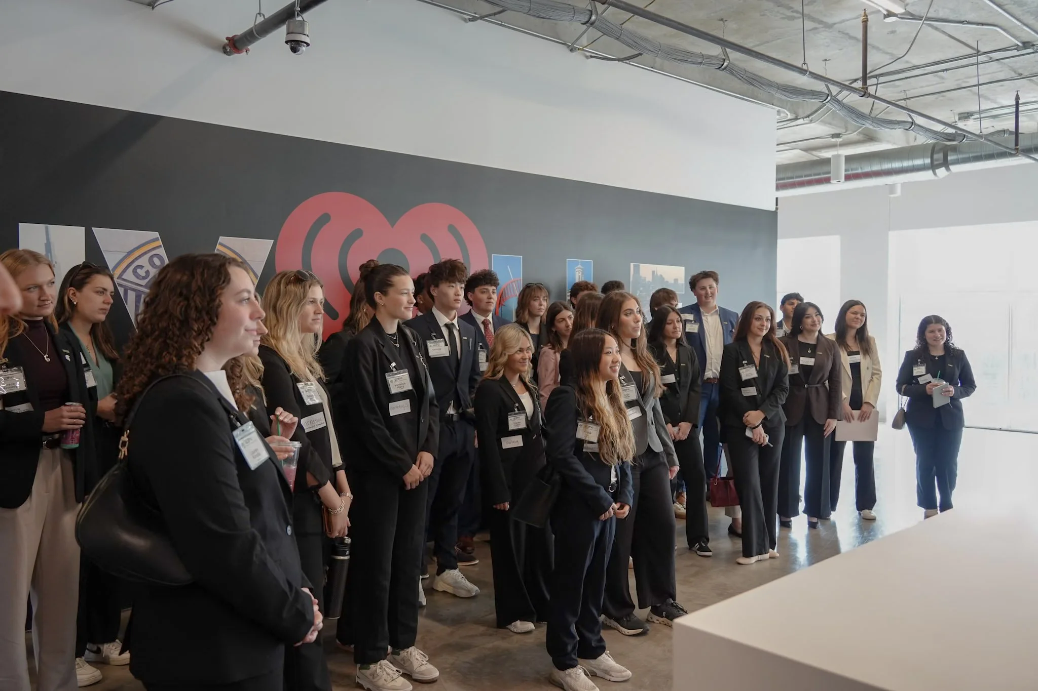 Group of young professionals and students at LinkedIn event, smiling for group photo in conference room with LinkedIn branding.