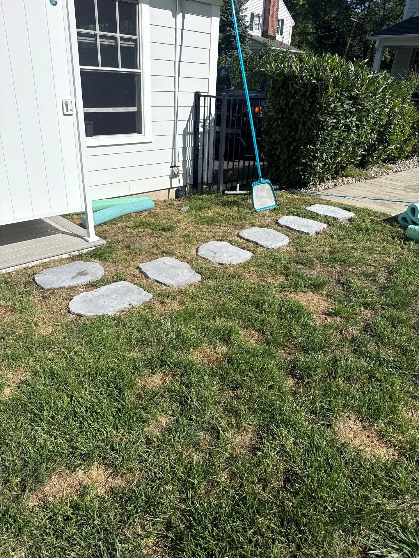 Stone stepping path gives a backyard lawn a clear route