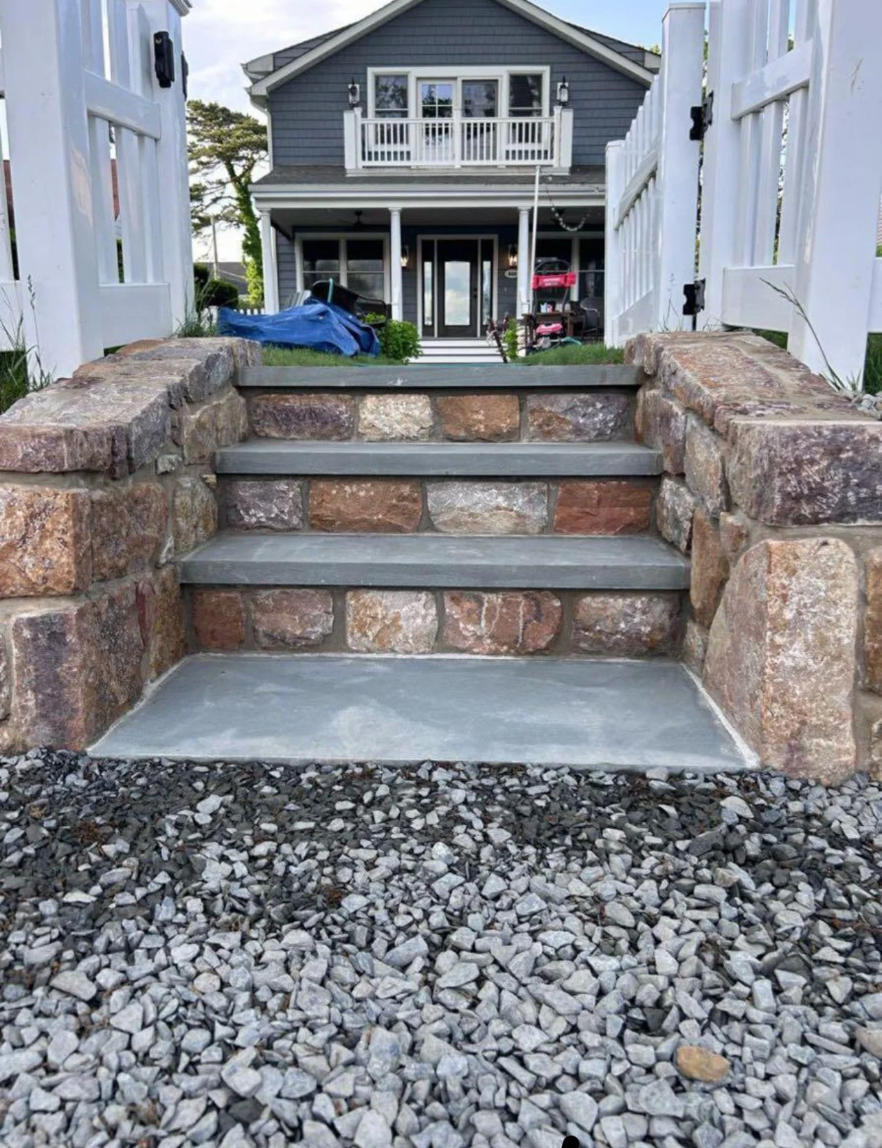 Stone steps installation at front entrance in Monmouth County NJ featuring natural stone walls and durable masonry stair construction.