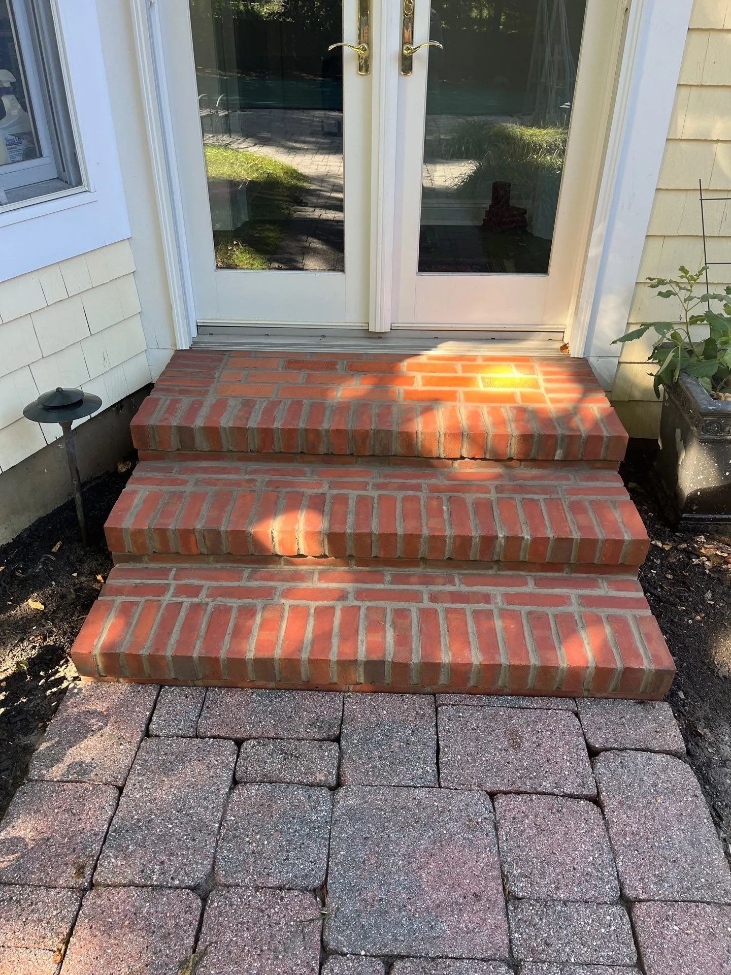 Brick step installation at front entrance in Monmouth County NJ featuring durable masonry construction and clean, level stair design.