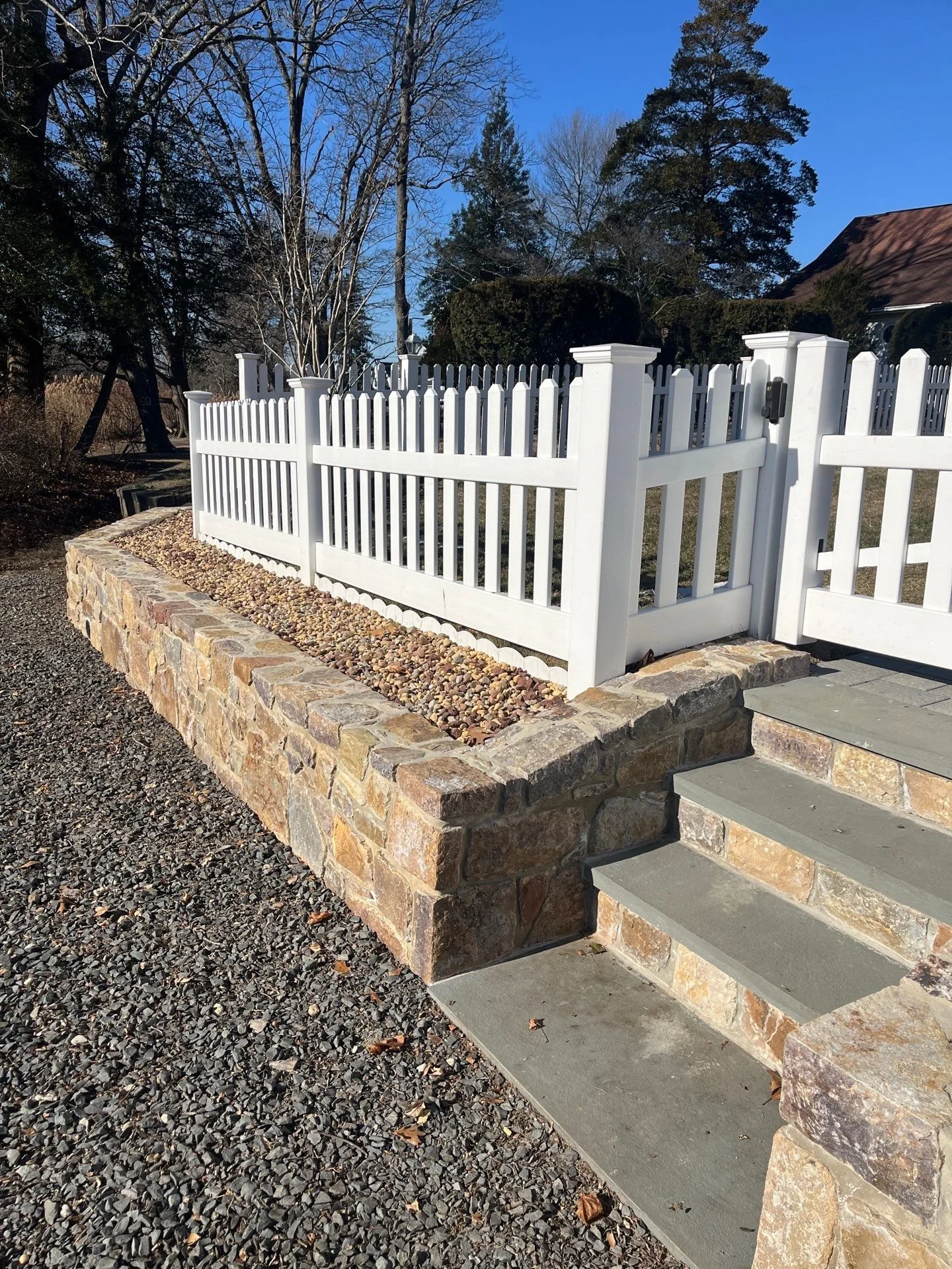 Stone retaining wall installation in Monmouth County NJ with natural stone masonry, steps, and landscape edging built for durability and curb appeal.