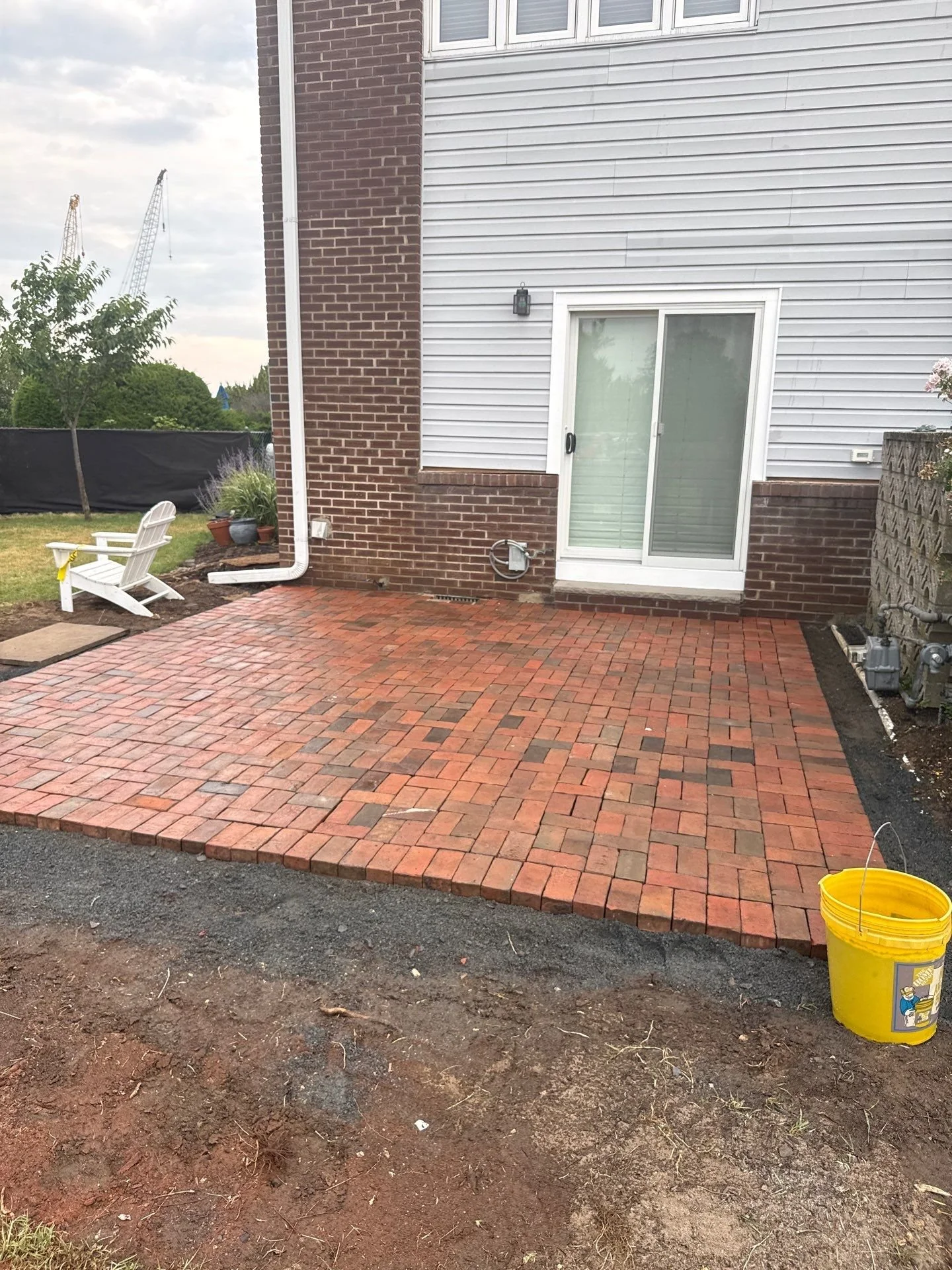 Brick paver patio at an Atlantic Highlands, NJ home featuring a running bond pattern and a soldier-course border along the back entrance.