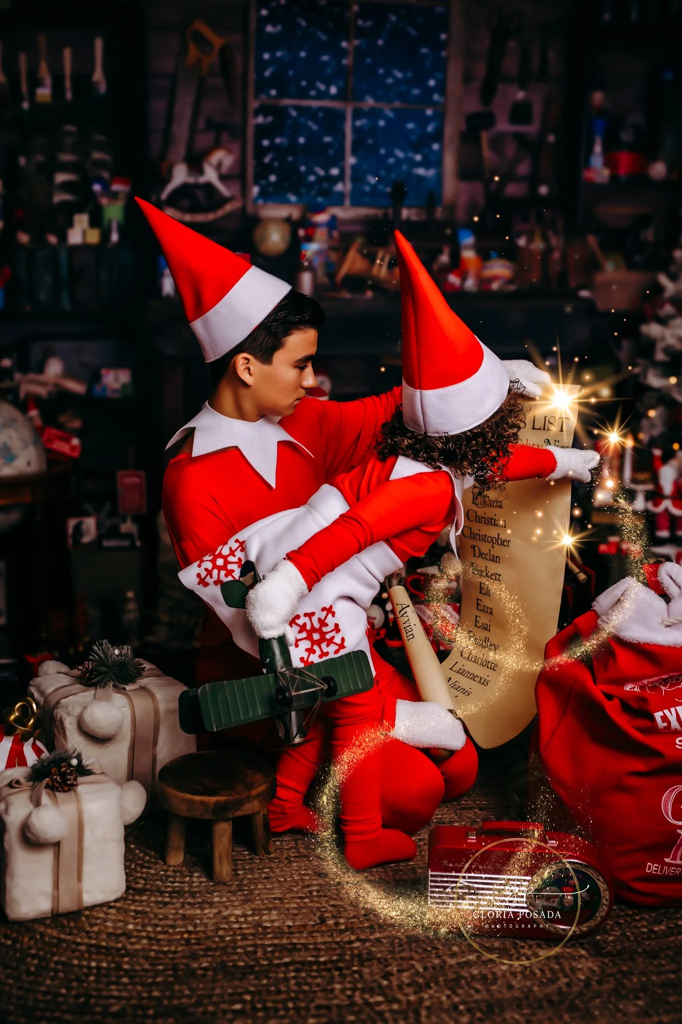 Children wearing elf outfits looking at a Christmas list.