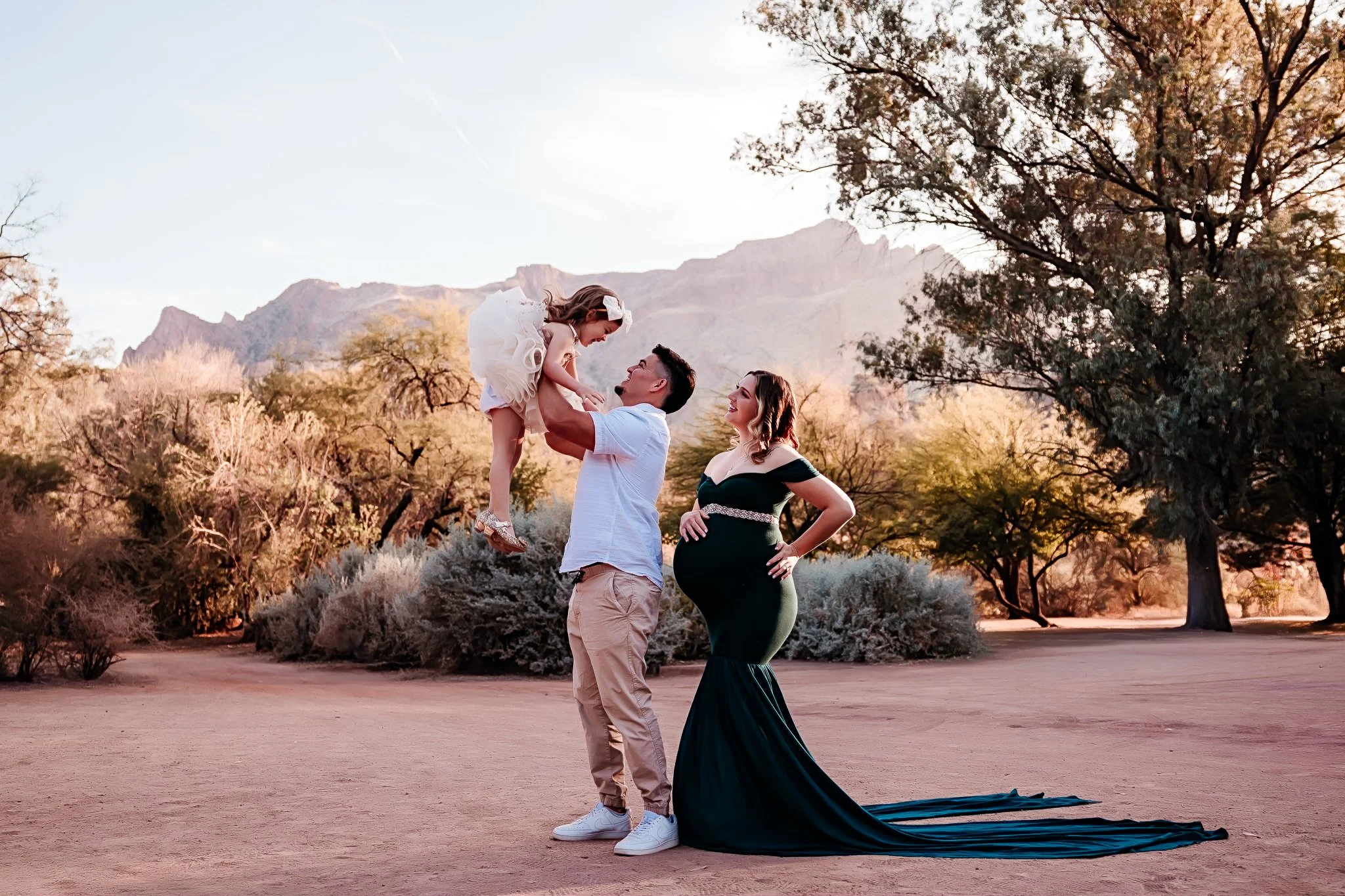 FAMILY OF 3 POSING FOR A PICTURE