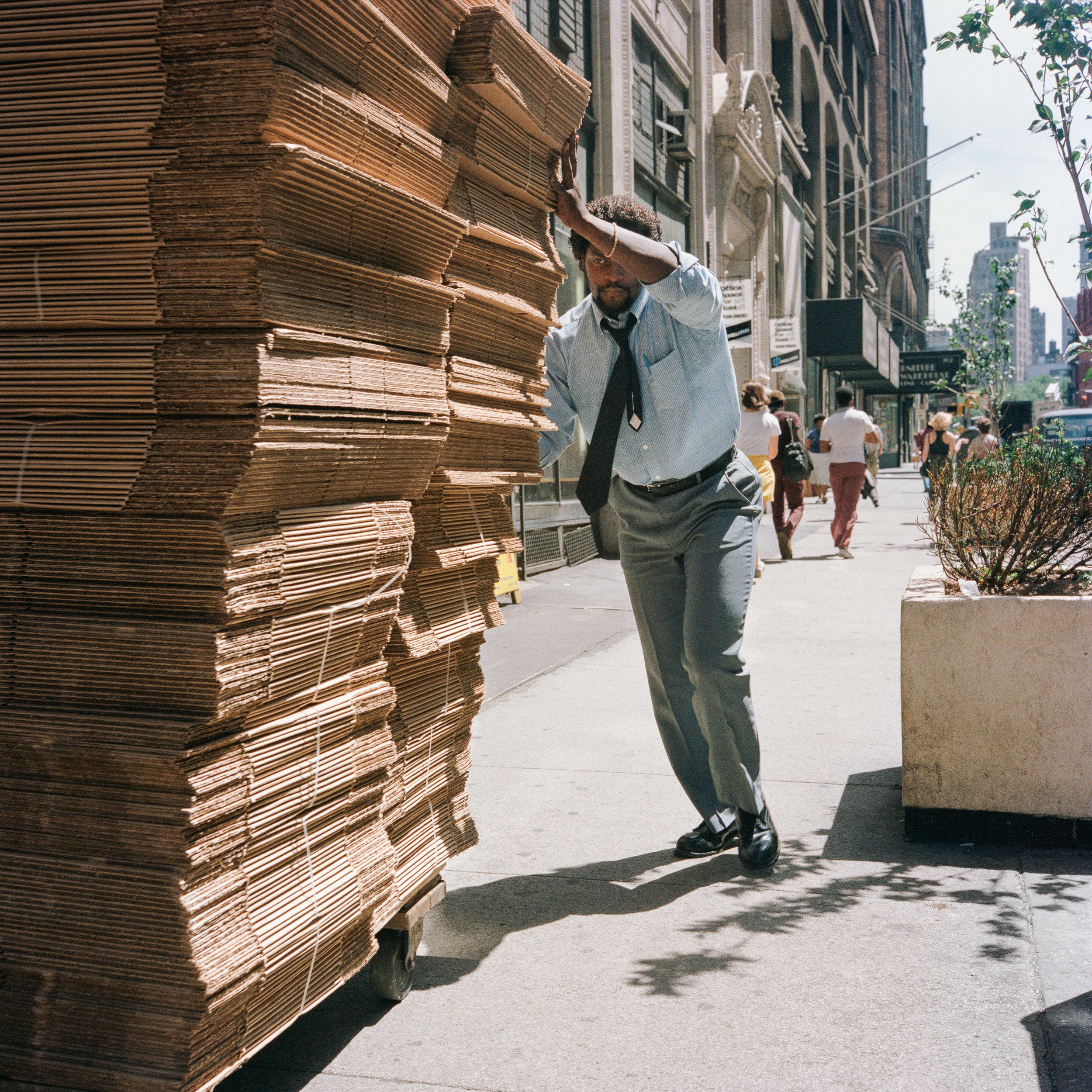   Man Pushing Stack of Cardboard, 1985  