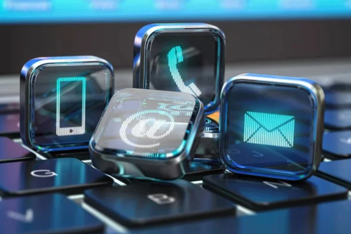 Close-up of four smartwatch icons showing phone, email, message, and QR code on a keyboard.