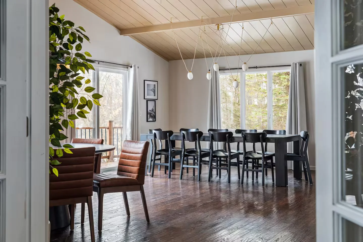 The grand dining room has vaulted ceilings and 2 separate dining tables, comfortably seating 16. Filled with natural light from numerous windows, the space is bright and airy. Direct patio access enhances the flow, perfect for indoor-outdoor living.
