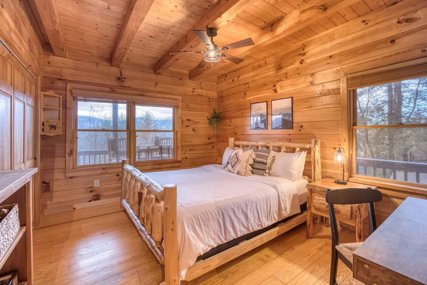 The main-level bedroom has a comfortable king bed, high-quality linens, extra pillows & blankets, smart TV, dedicated workspace, board games, and ample clothing storage, and windows that showcase the beautiful mountain views right from your cozy bed!