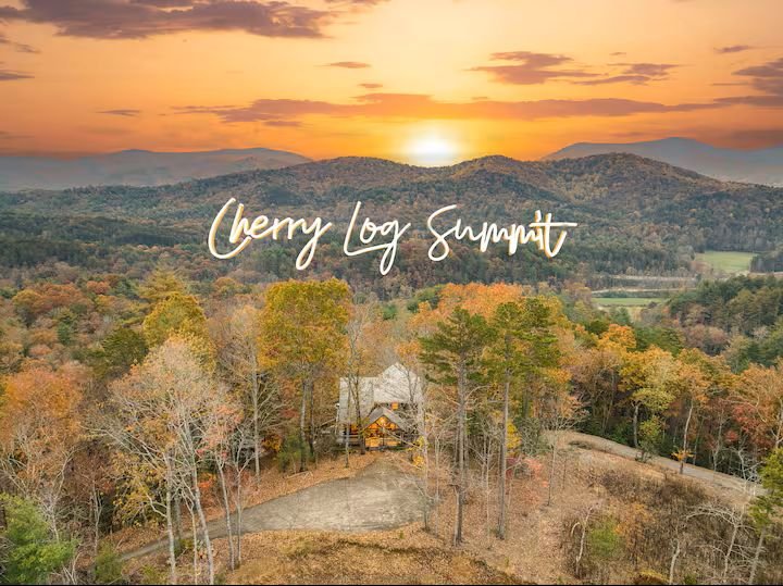 A stunning aerial view reveals the vibrant fall colors and rolling ridges that surround Cherry Log Summit. Tucked in total privacy and peaceful seclusion, this cabin sits high above the treetops, offering pure North Georgia mountain serenity.