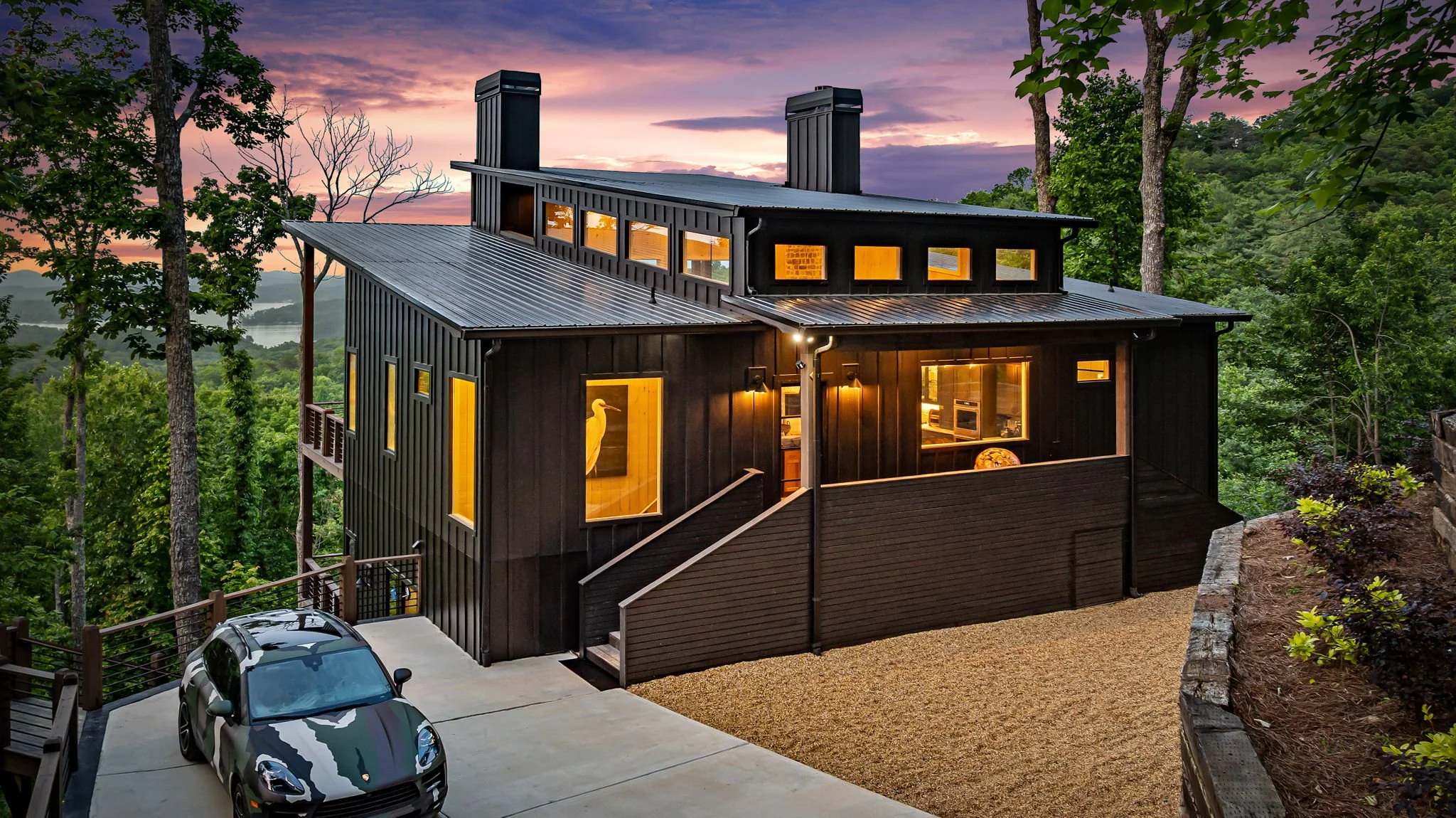 Arrive at this striking modern mountain retreat featuring private driveway parking, sleek architectural design, expansive decks, forest surroundings, and panoramic mountain views—an elevated luxury escape designed for style, comfort, and more.