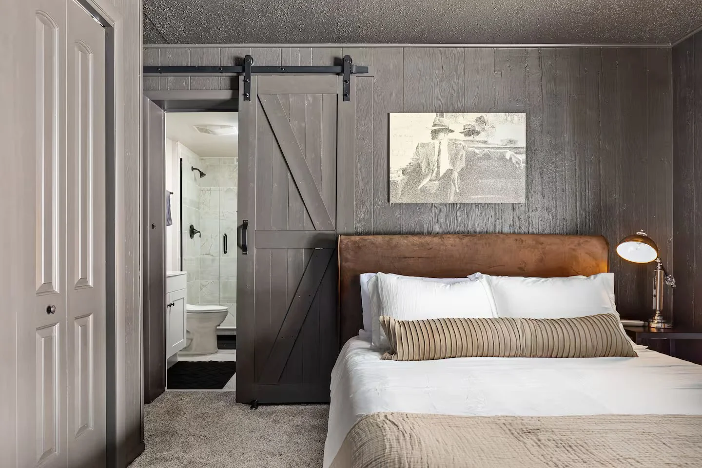 “Bedroom 2” downstairs master w/ queen-size bed and en-suite bathroom with a shower. The bathroom is stocked w/ toiletries and necessities for your convenience. Direct patio access opens to the backyard, offering plenty of space for relaxation & fun.