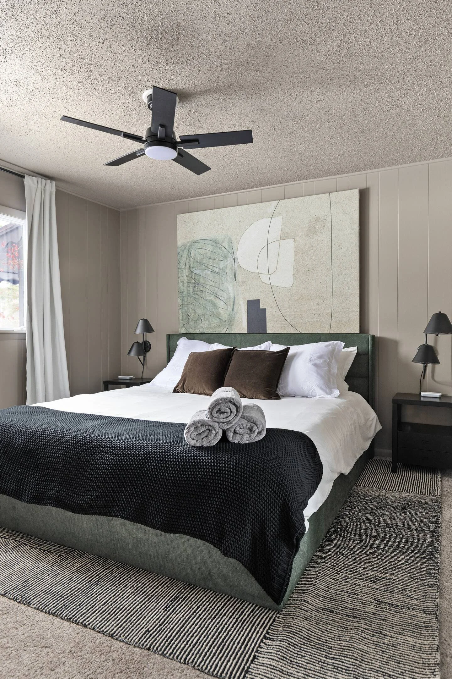 “Bedroom 1” is a cozy and comfortable king-size bed on the main level, just off the dining room and adjacent to Bathroom 1. With an east-facing window, it captures the sunrise, offering a serene start to the day and easy access to your morning coffee