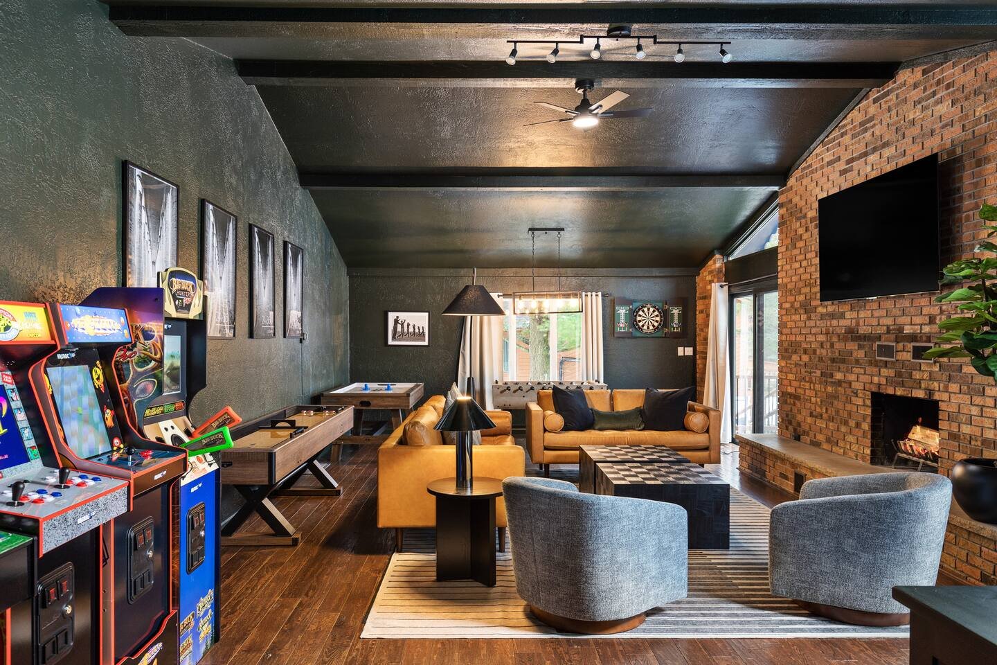 The game/living room is a stylish, well-designed space that blends class with fun. Packed with arcade games, shuffleboard, air hockey, foosball, & a 75-inch smart TV, it also has direct access to the back patio for seamless indoor-outdoor enjoyment!
