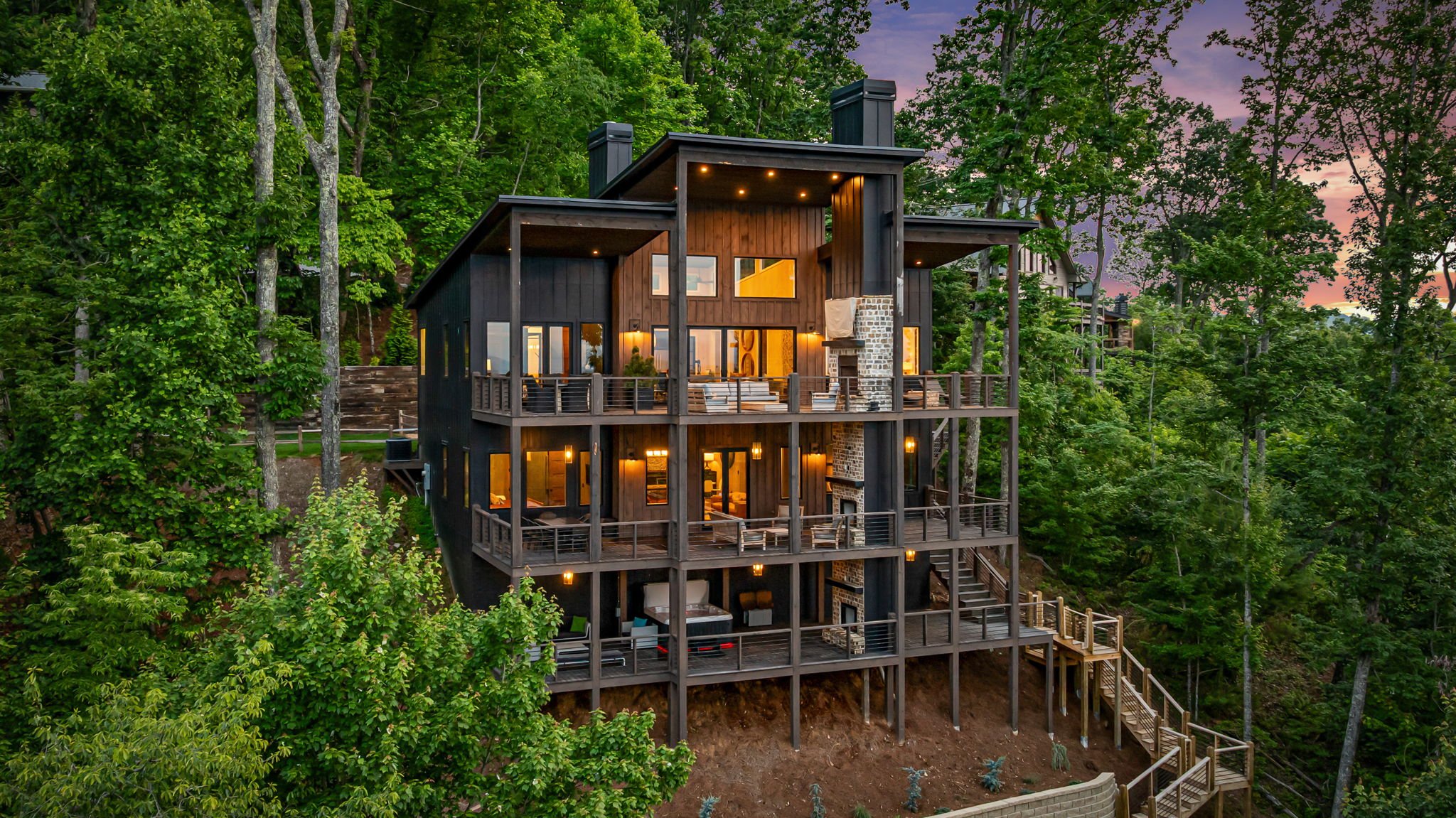 Discover this striking modern mountain retreat with expansive decks and floor-to-ceiling windows framing breathtaking mountain & lake views. Sophisticated design, upscale finishes, and elevated outdoor living create a refined luxury escape.