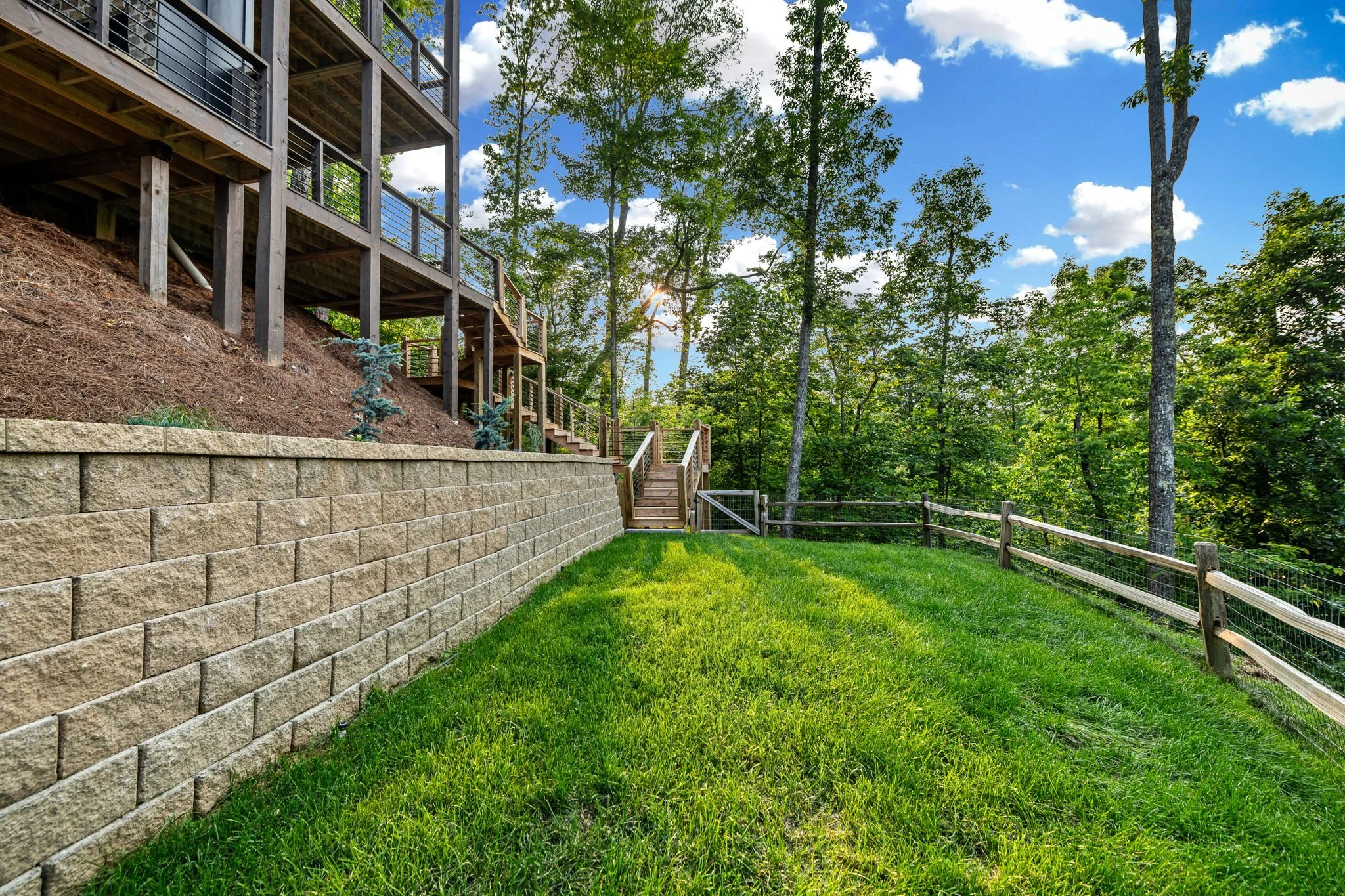 Enjoy the private fenced backyard with lush lawn, wooded surroundings, and easy deck access—a peaceful outdoor space perfect for relaxing, letting pets roam safely, or enjoying fresh mountain air.