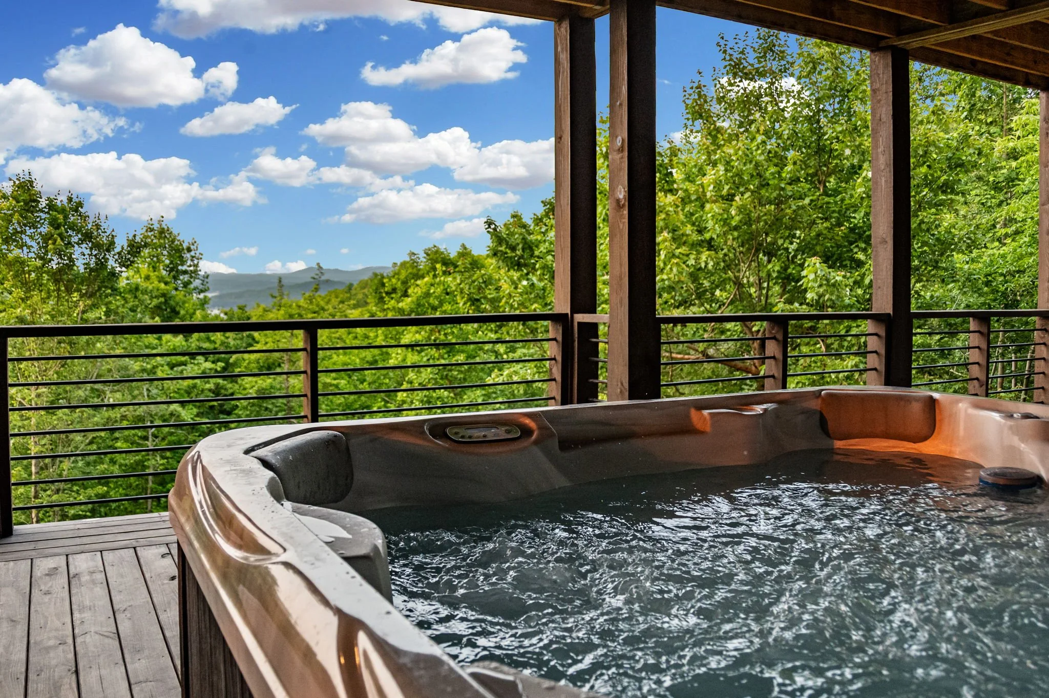 Relax in the private hot tub while soaking in sweeping mountain and lake views. Covered outdoor living, serene forest surroundings, and elevated design create the perfect setting to unwind and enjoy the beauty of this luxury mountain retreat.