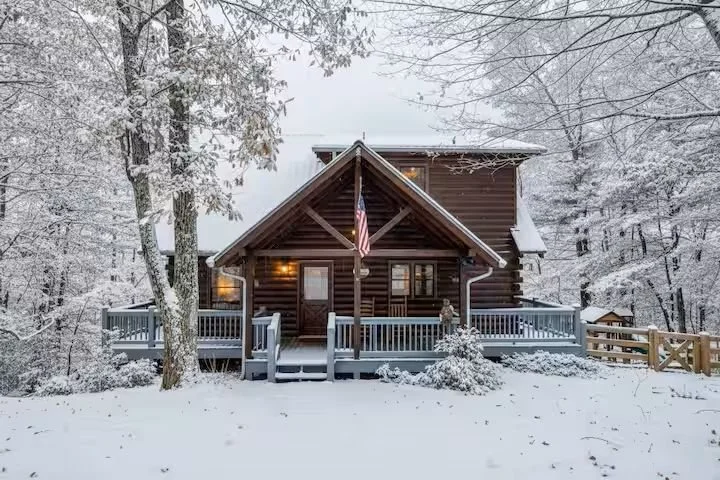 Cherry Log Summit welcomes you with a warm, inviting front porch framed by winter mountain scenery. Perched on a secluded hilltop, you’ll arrive to breathtaking views and a cozy North Georgia retreat tucked quietly among the trees.