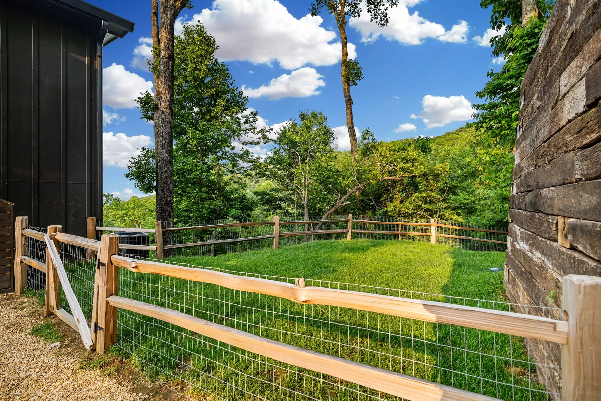 Enjoy the private fenced yard featuring lush green space and wooded surroundings—perfect for relaxing outdoors, enjoying fresh mountain air, or giving pets a safe space to play.
