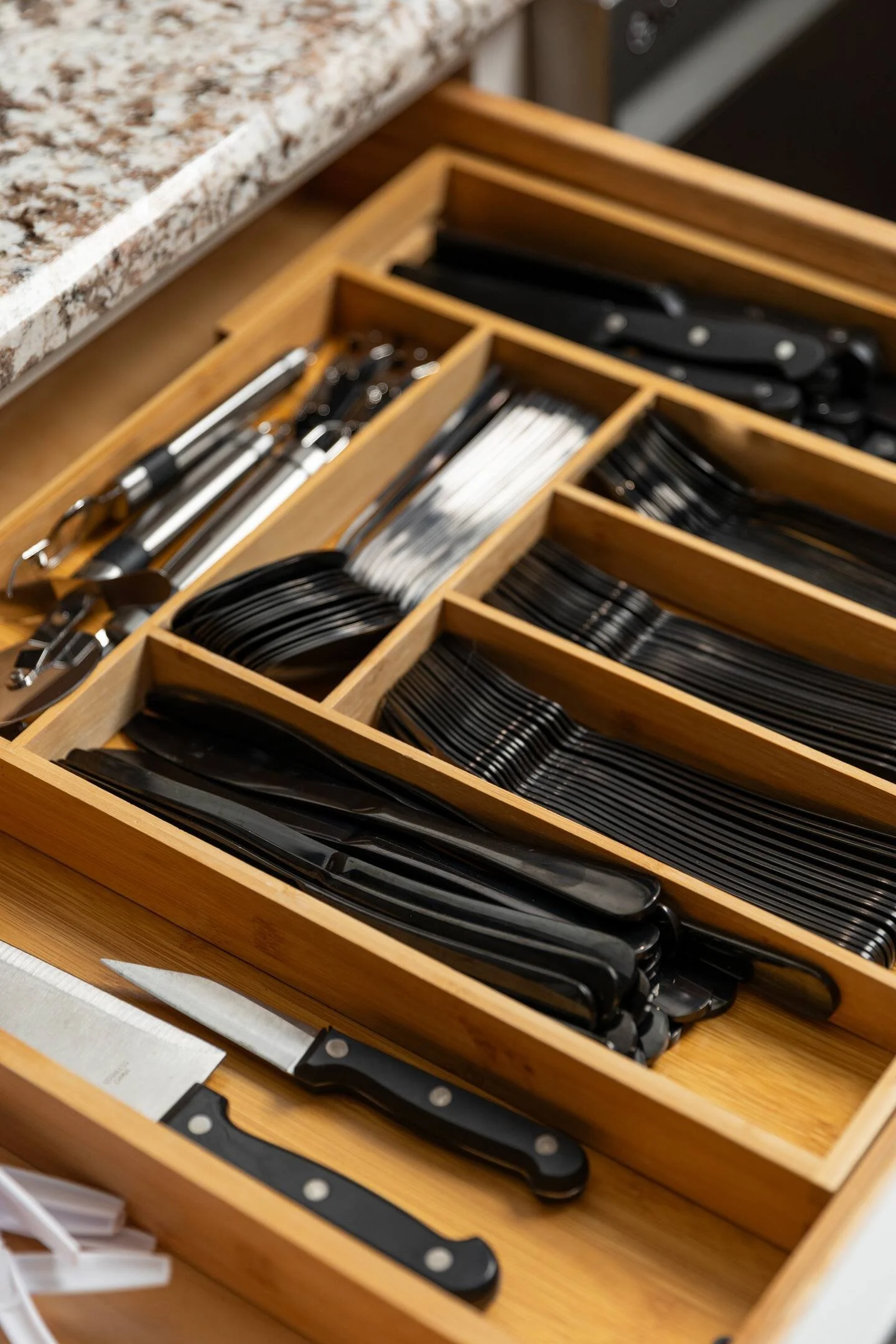 A fully stocked kitchen includes spices, silverware, plates, bowls, children's dinnerware, 2 crockpots, blender, toaster, knife set, pots, pans, baking sheets, drinking glasses, wine glasses, beer glasses, coffee mugs, barbecue utensils, and more.

