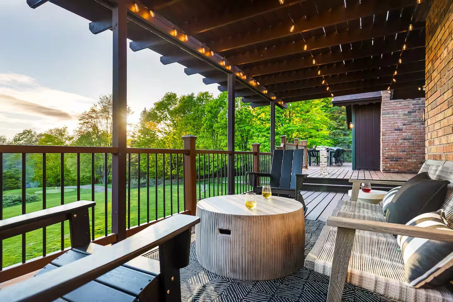 The spacious back patio has plenty of lounge seating and room to enjoy the weather and take in a beautiful sunset. Grab your favorite rocking chair or spot under the shaded pergola (with overhead string lights) after a long day of golfing or boating!
