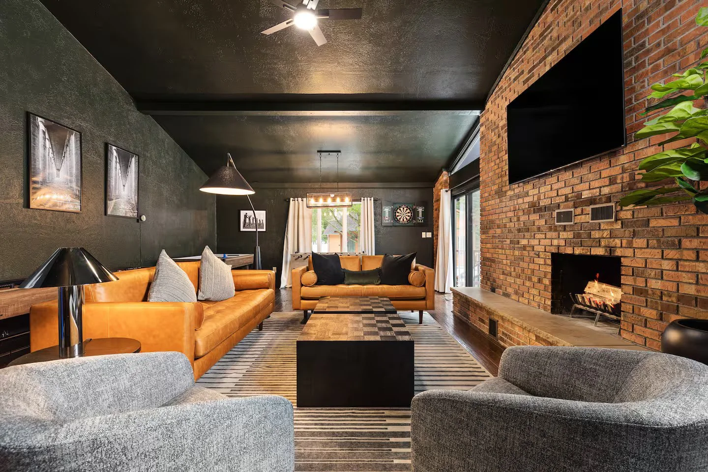 The living room is packed with style, yet functional for all with plenty of seating. Warm and inviting yet sleek and classy, it’s the perfect spot to relax, whether you’re watching a football game or reminiscing around a fire with friends + family!
T