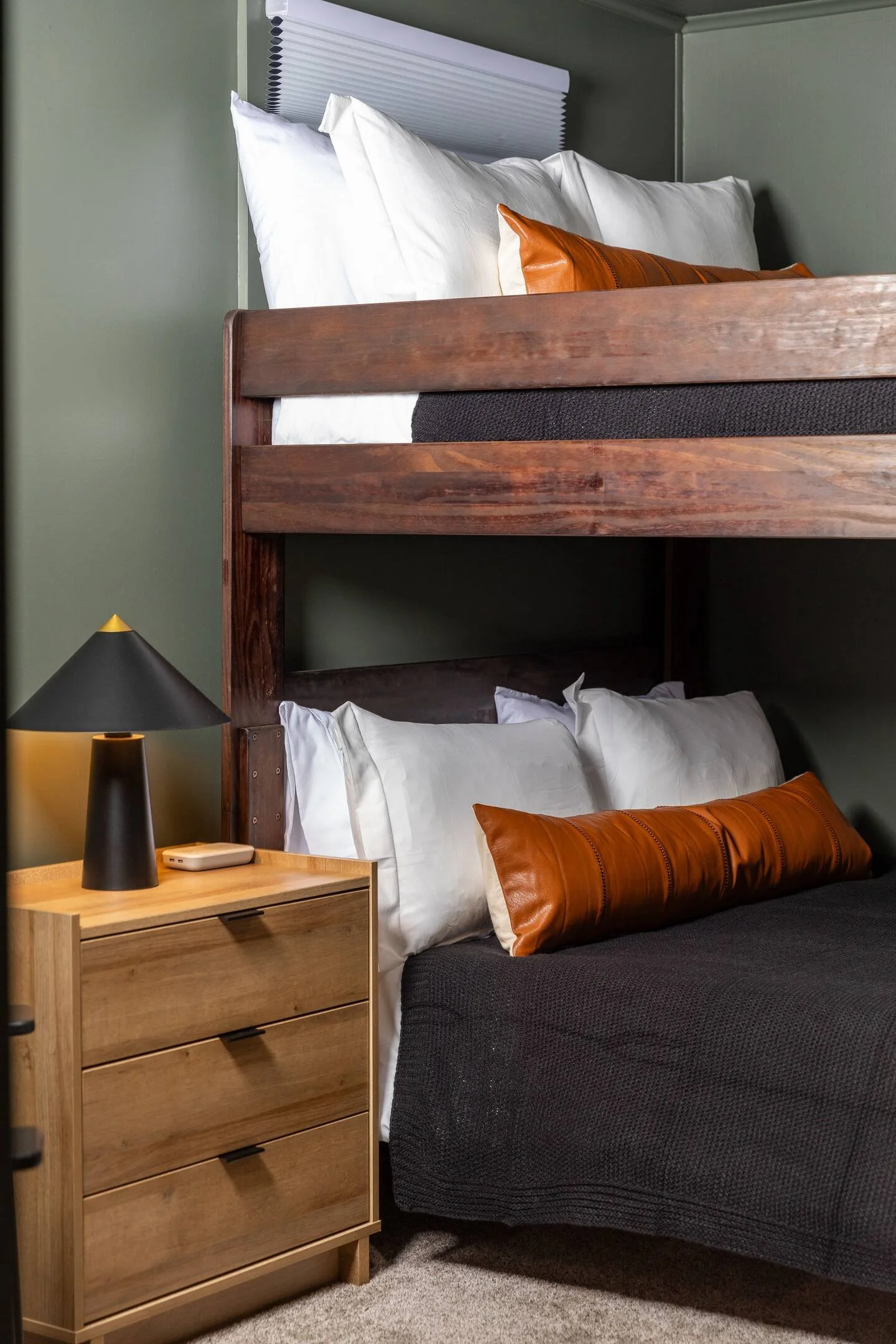 “Bedroom 5” is a bunk room with comfy queen-over-queen bunk beds, 2 closets, a smart TV, and wireless phone chargers. It also provides access to the laundry room, making it a great, quiet space for a restful night’s sleep or extra room for the kids.
