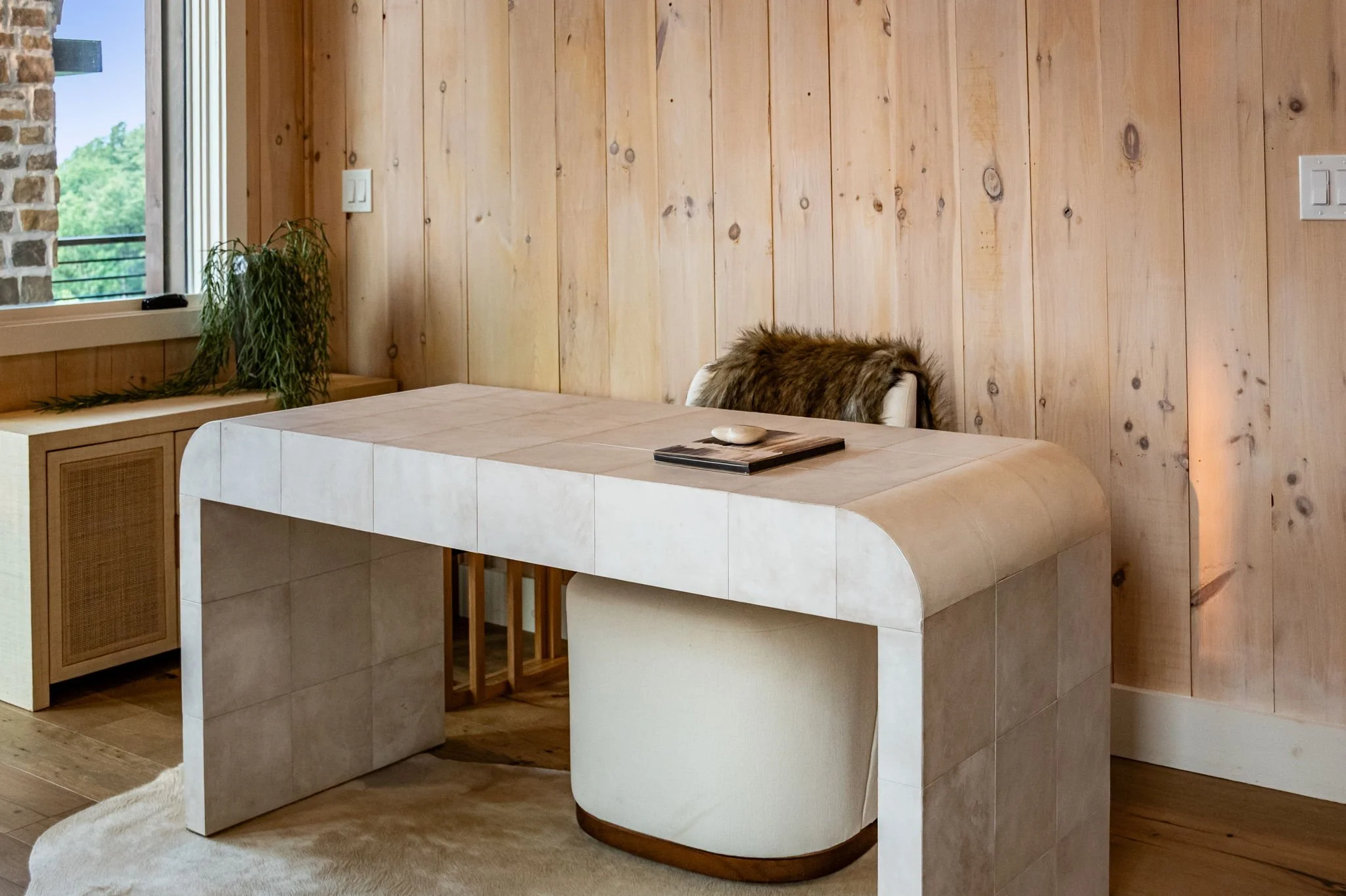 Work comfortably in this stylish workspace featuring a modern designer desk, cozy seating, natural light, and serene mountain surroundings—perfect for remote work, or planning your next adventure while enjoying the peaceful luxury retreat atmosphere.
